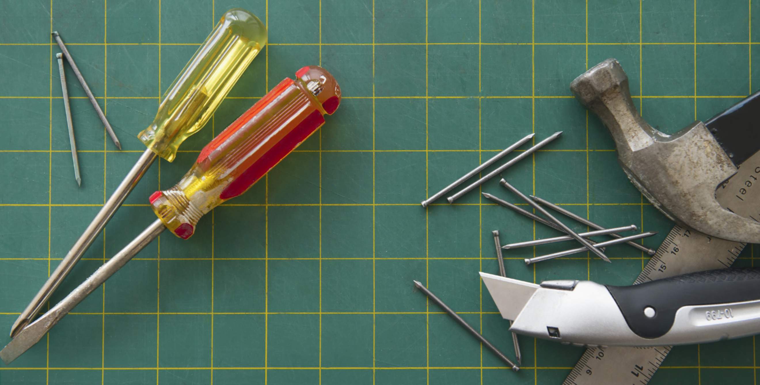 A hammer and other tools on a blueprint.