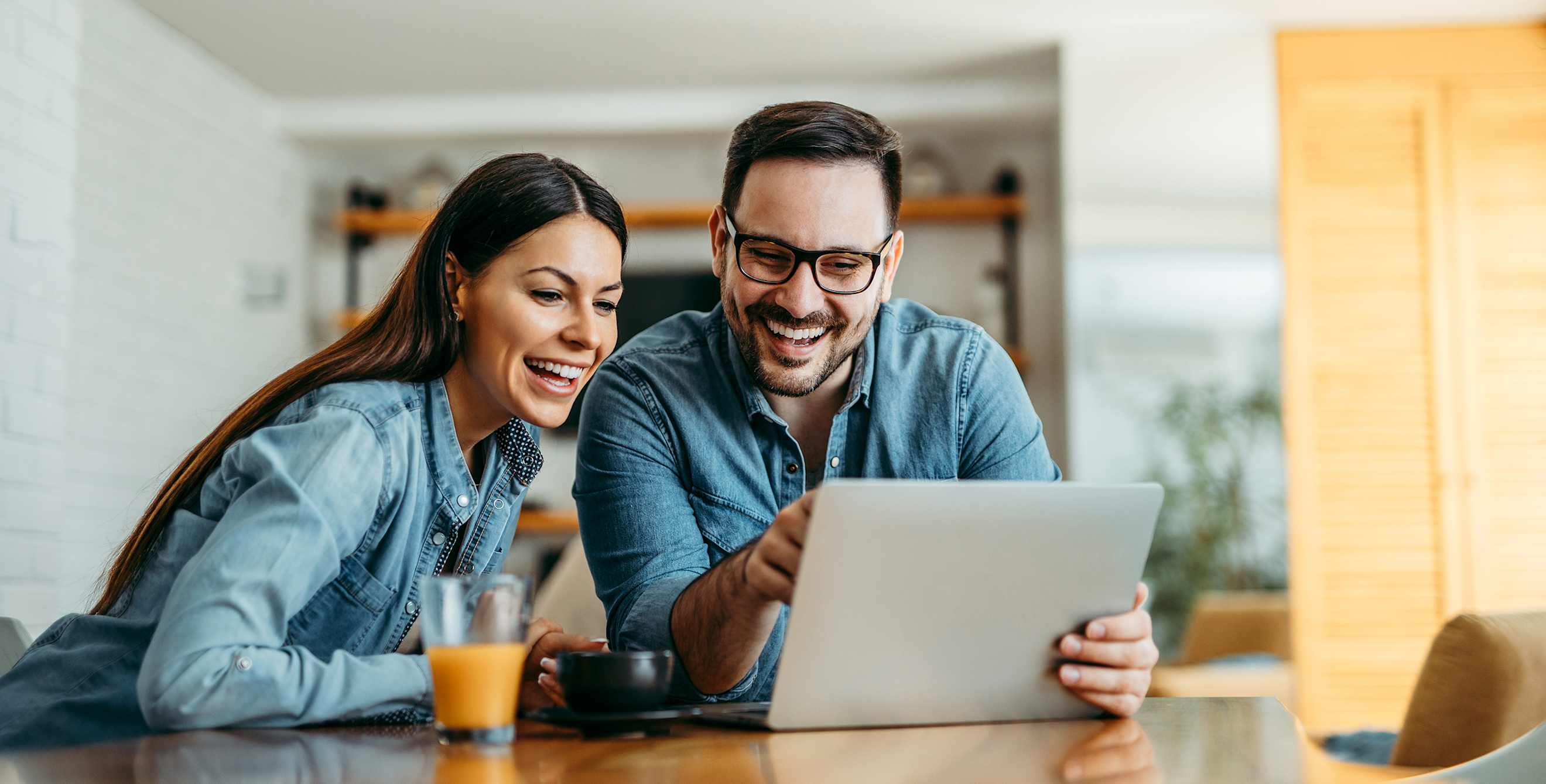 A couple looks at house listings on Zillow, Redfin, and Realtor.com