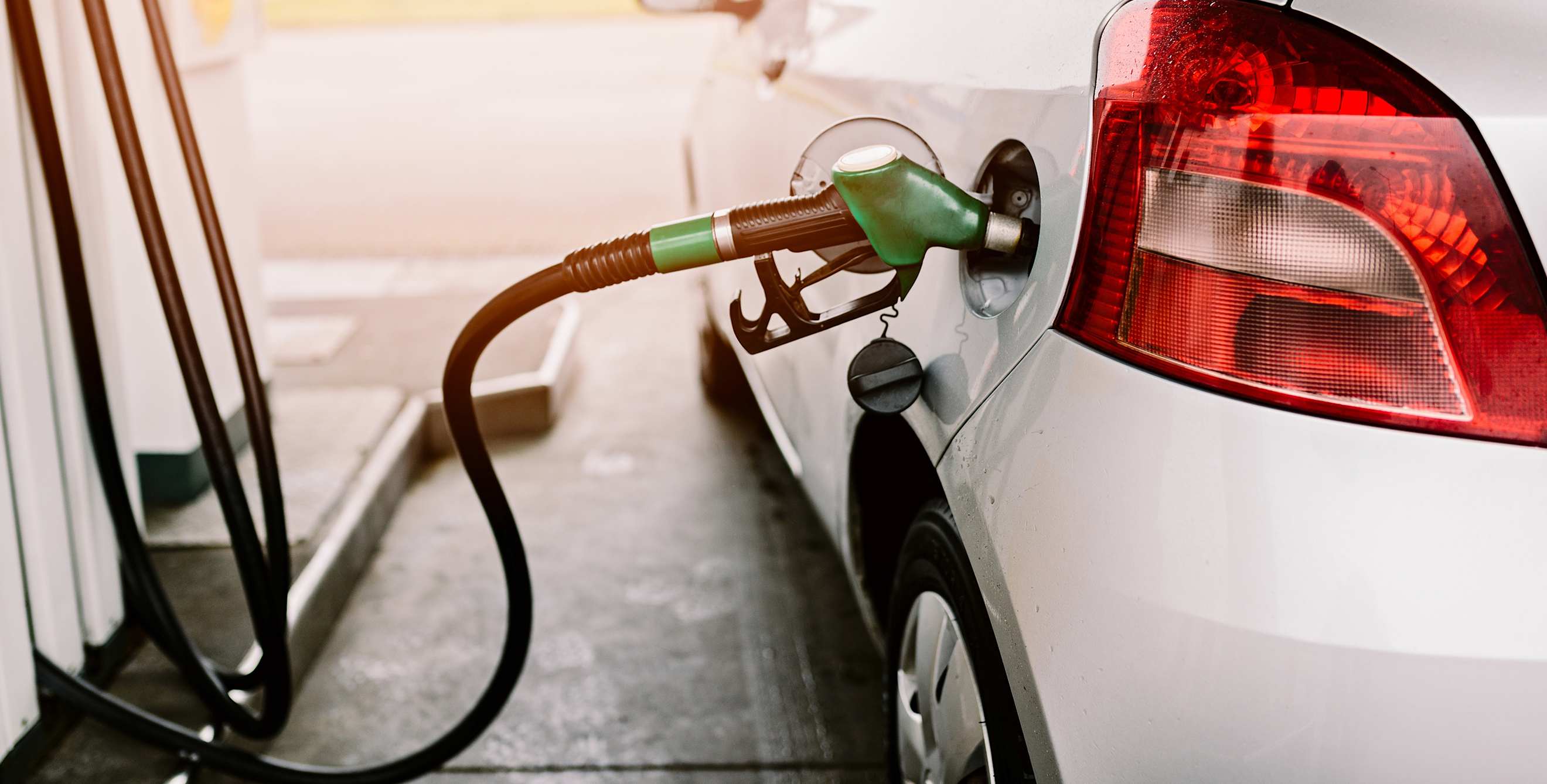 A car at the pump at the gas station.