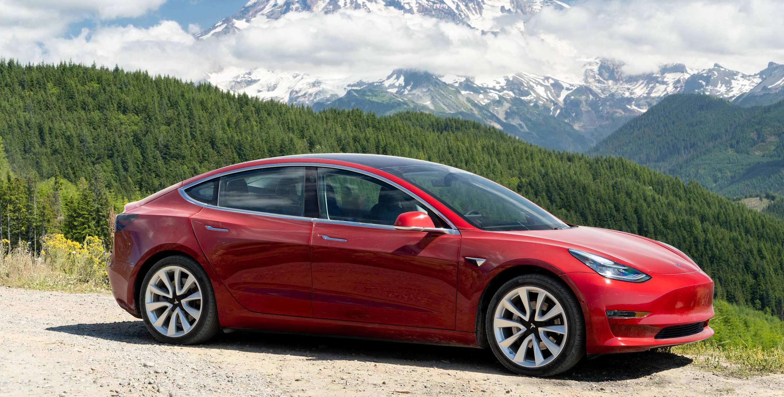 Tesla Model 3 parked with mountain views in Calgary, Alberta.