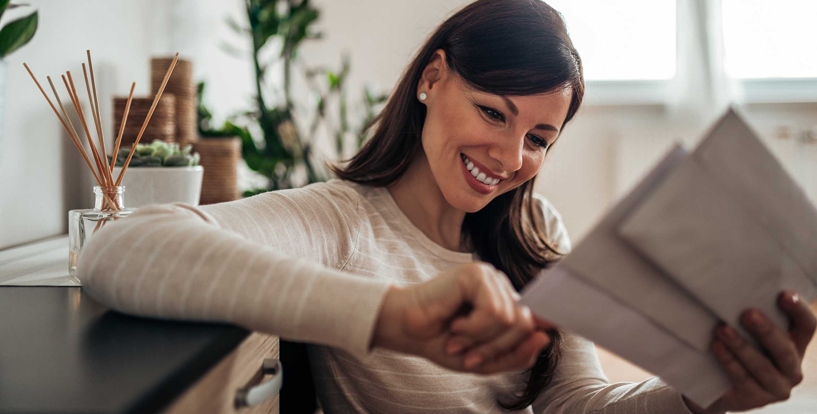 A woman looks at her bank statements.