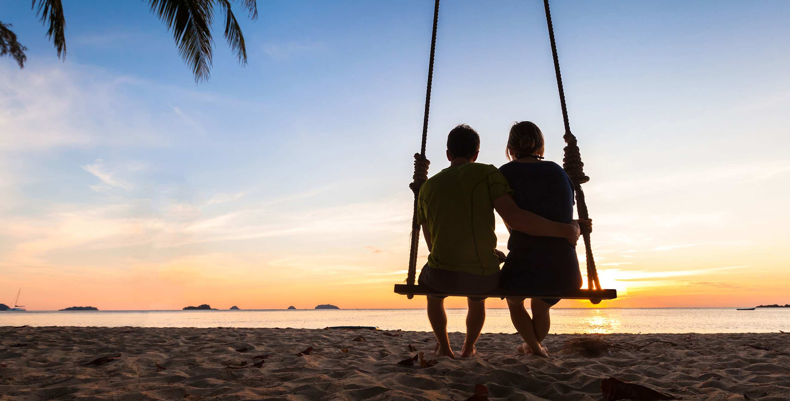 Couple enjoys a honeymoon booked by a AAA Travel Agent