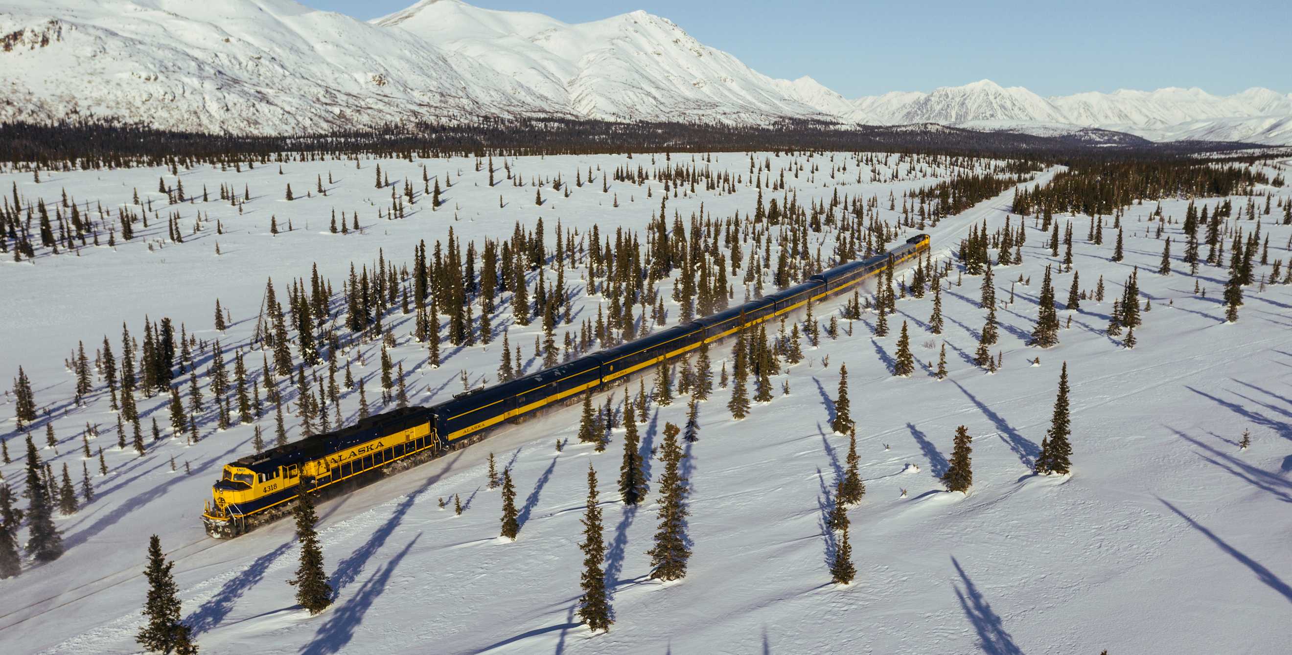 Aurora Winter Train glides through the snowy landscapes of Alaska.