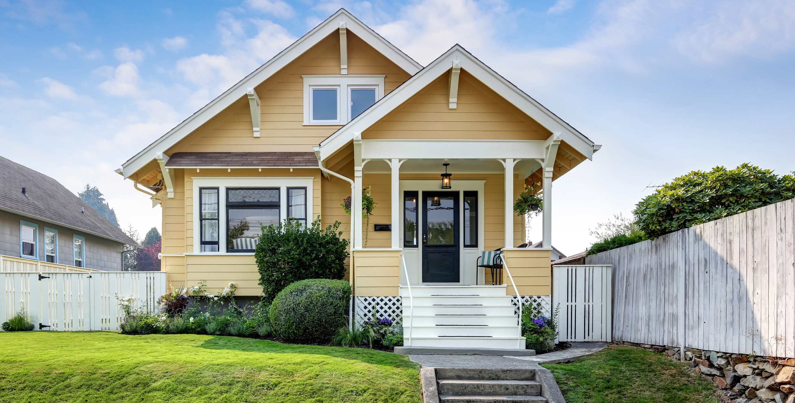 An old Crafstman house painted yellow.