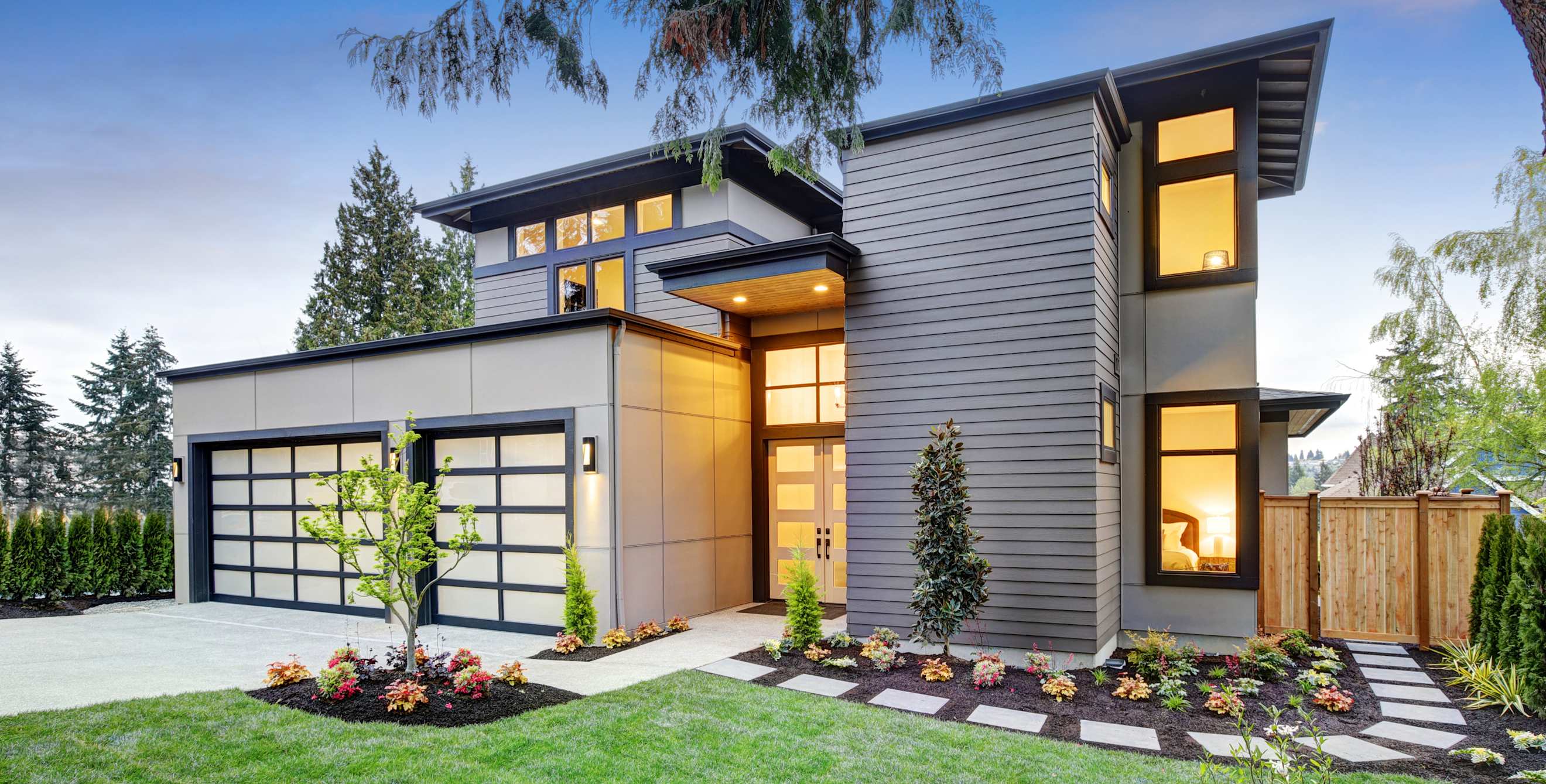 A new home lit up at dusk.