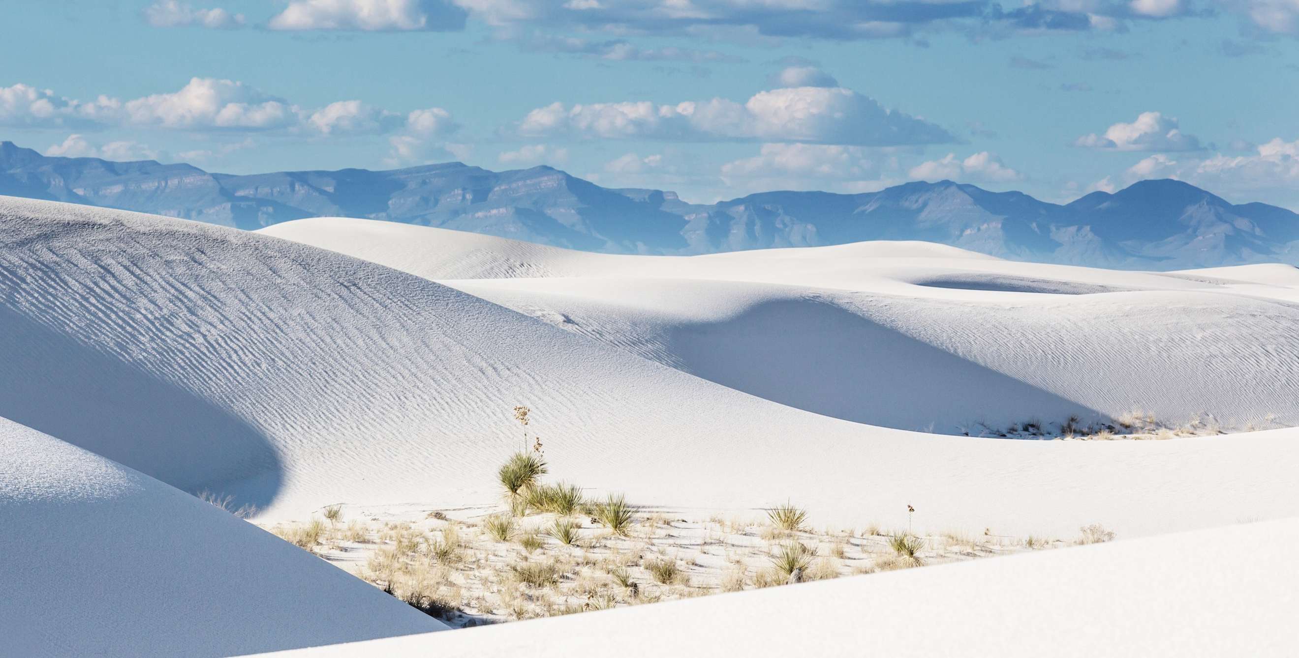 White sand dunes set against blue skies at White Sands National Monument, picture