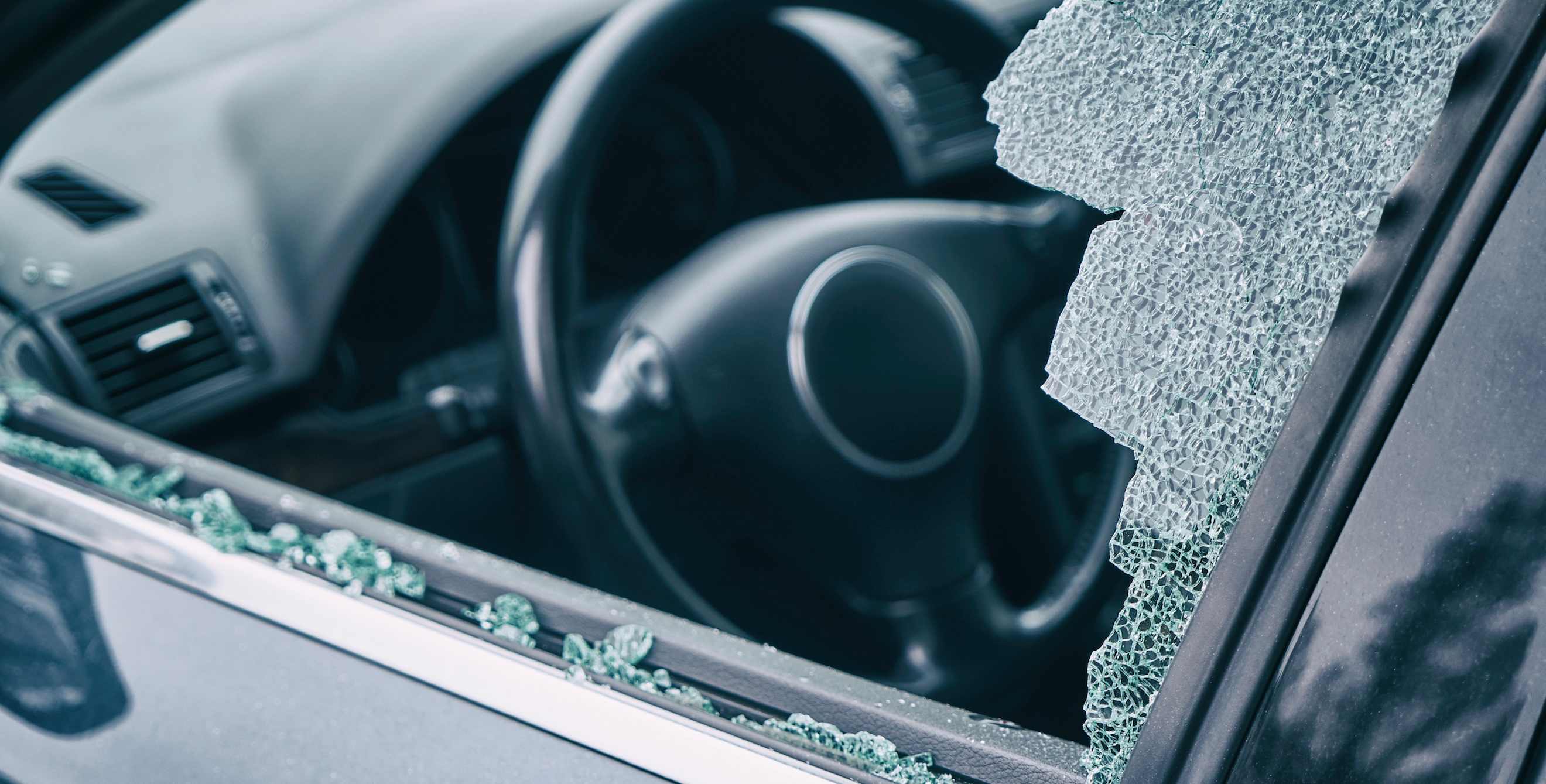 shattered glass around a broken car window