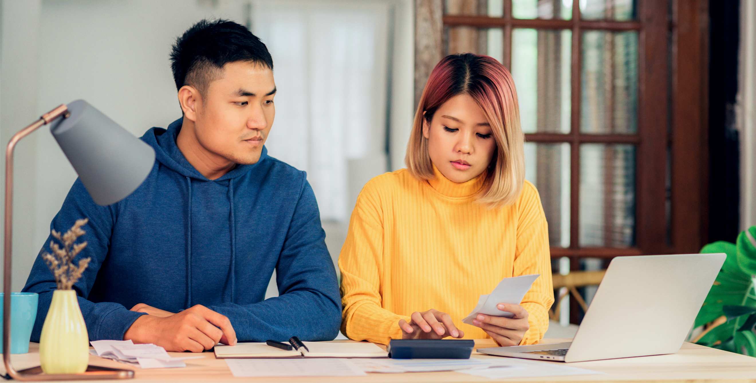 A couple calculates their assets.