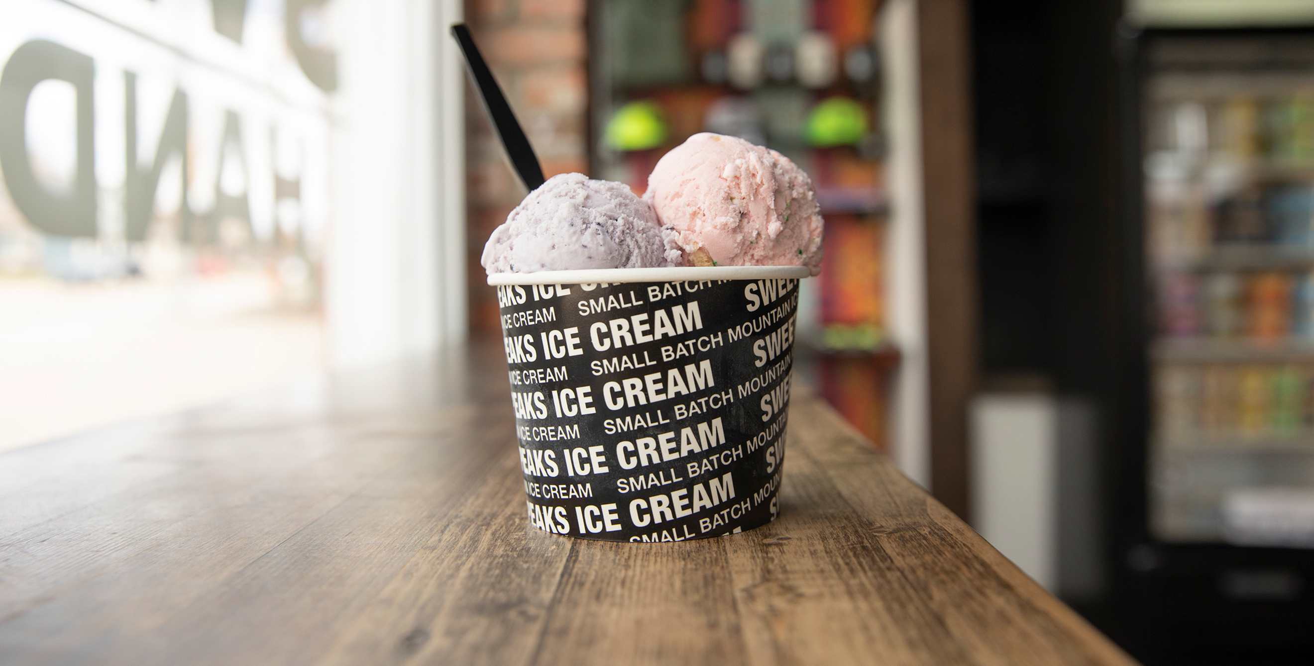 A cup of oce cream sits on the bar counter at Bozeman's Sweet Peaks West Main location.