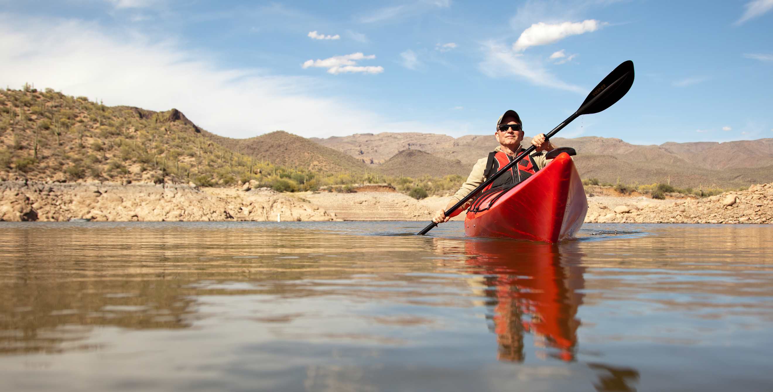 A man kayaks on a lake in Arizona.