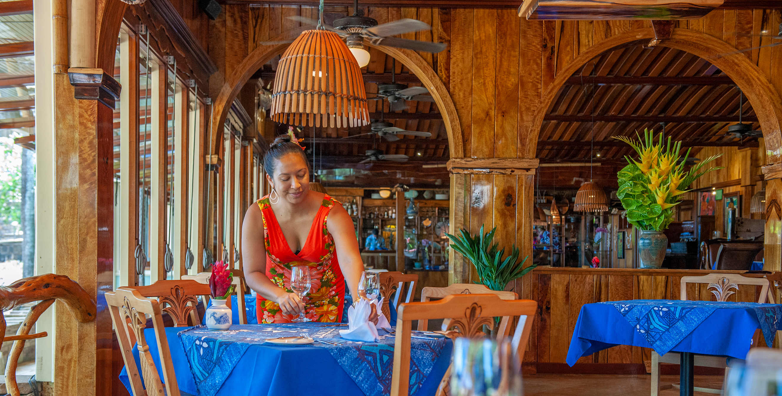 A server sets a table inside Mama's Fish House in Paia, Hawaii