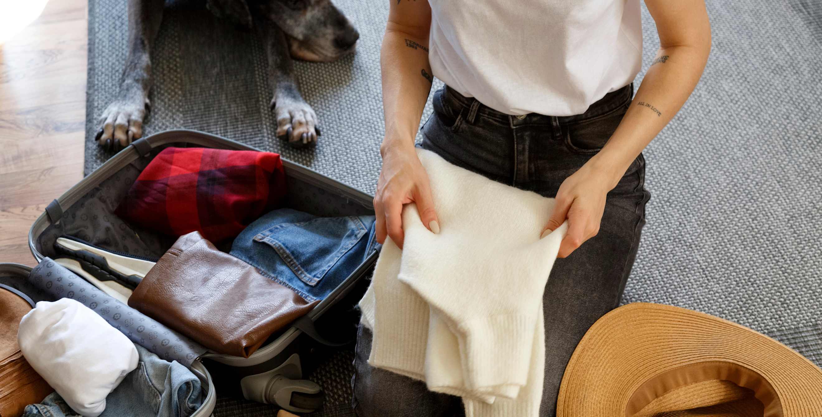 clothes being stuffed into a suitcase, picture