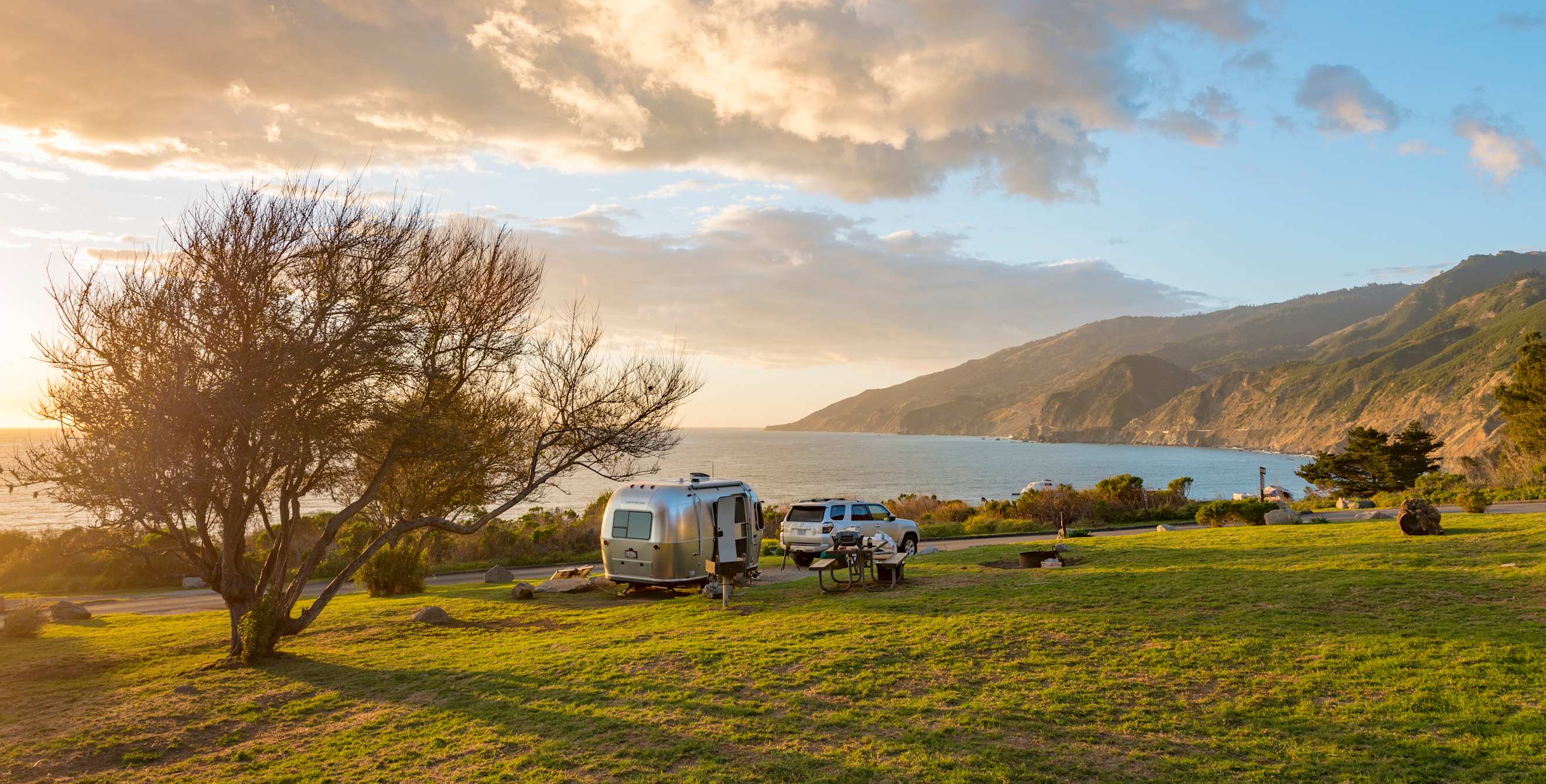An airstream trailer parked at an ocean-side campsite at Kirk Creek Campground along Highway 1 in Big Sur, California.