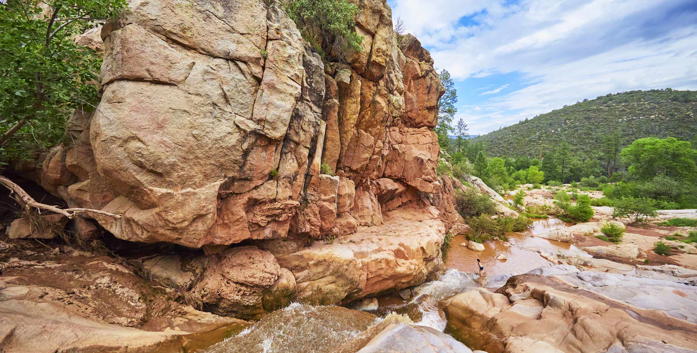 People wade into the swimming hole at the end of the Water Wheel Falls trail near Payson, Arizona.