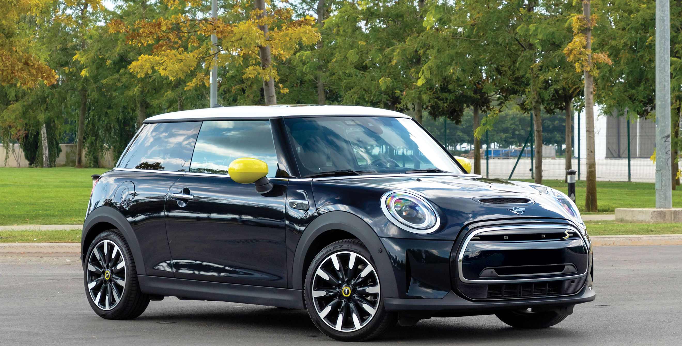 A Mini Cooper SE Electric parked in an empty lot.