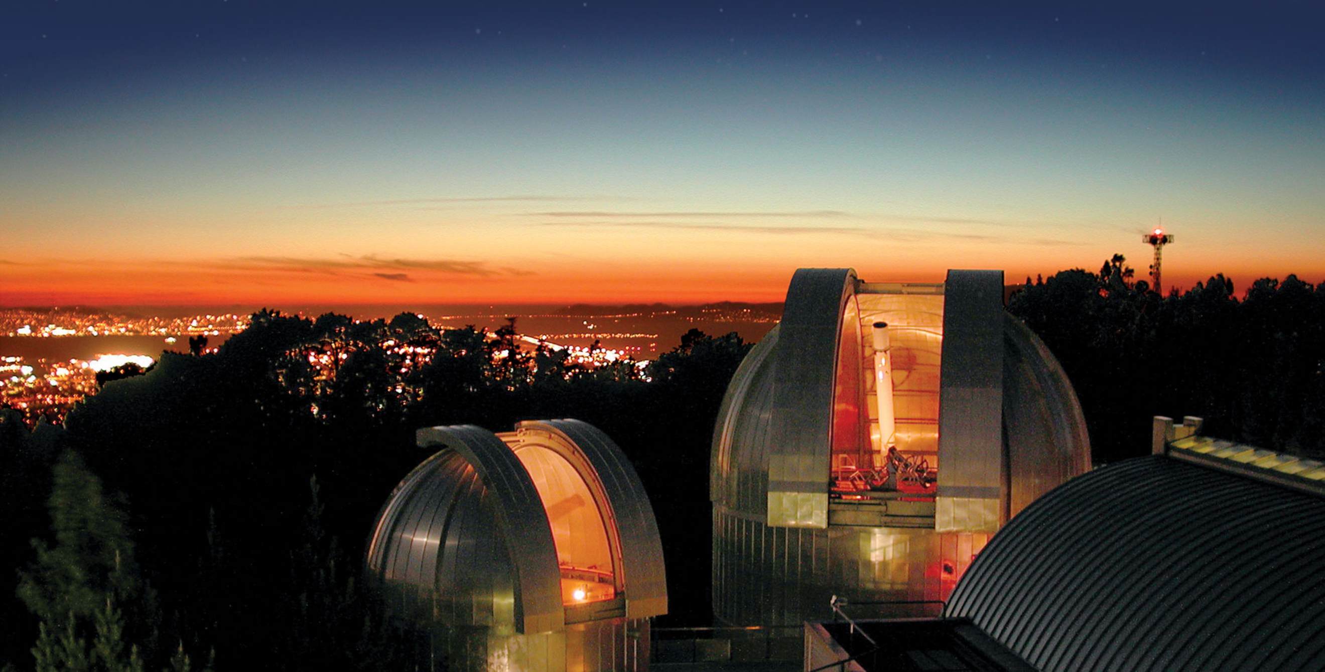 Chabot Space and Science Center at night overlooking downtown Oakland, California.