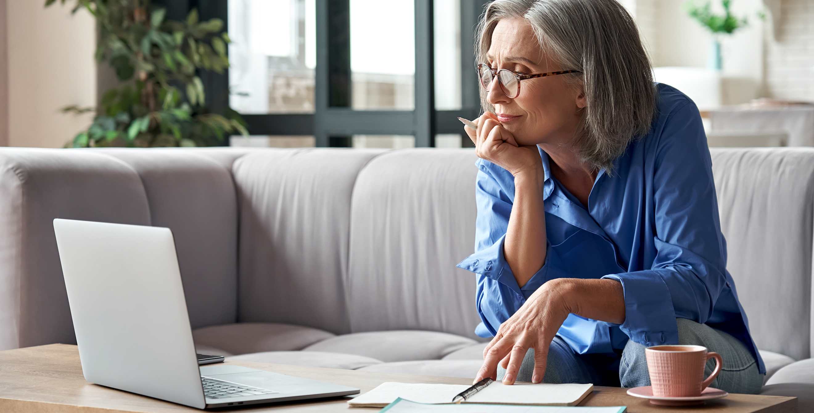 A woman looks at her retirement accounts on her computer.