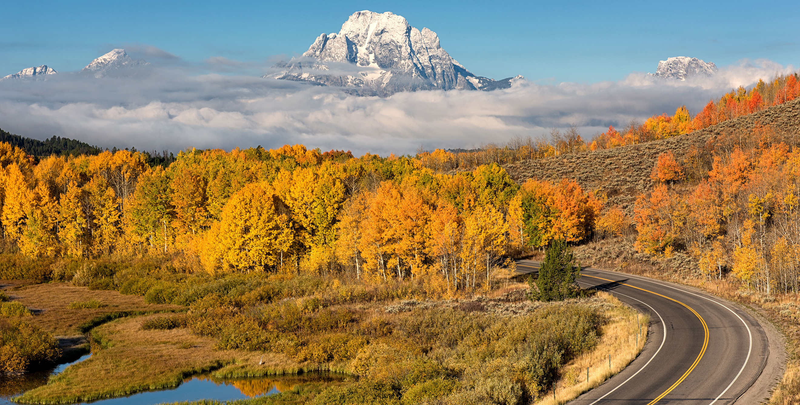 Mt. Moran overlooks a winding road in Wyoming's Teton National Park.