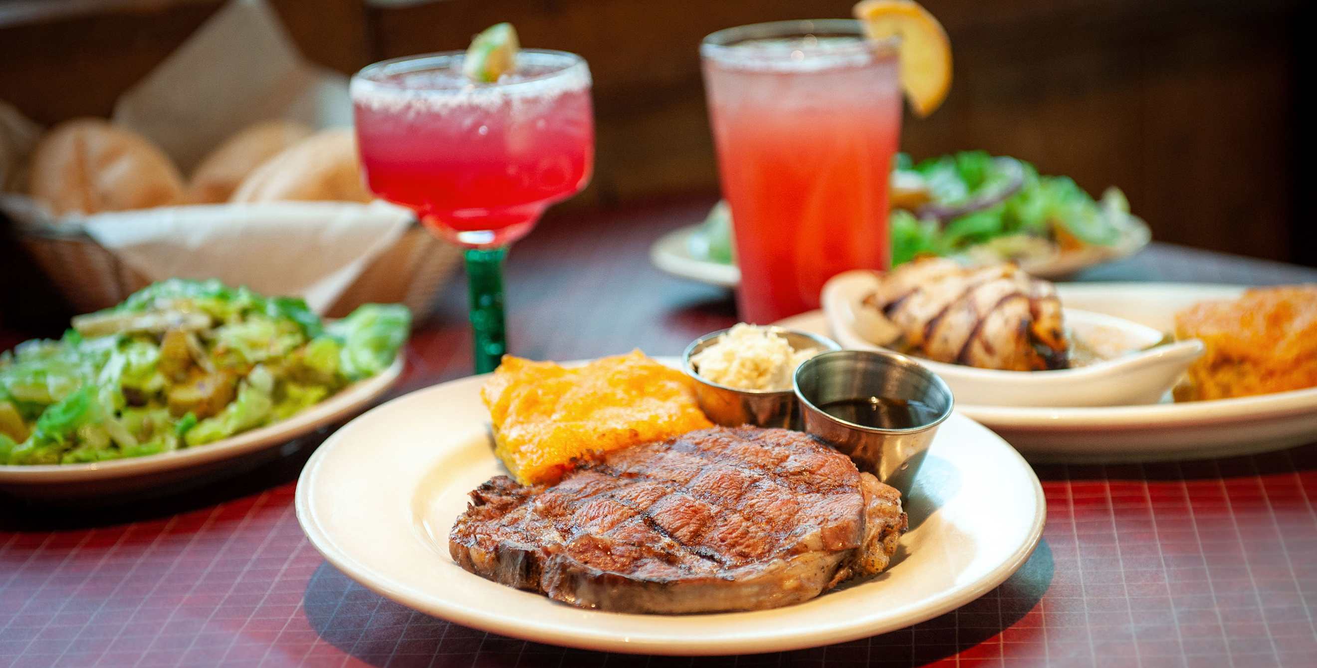 Plates and cocktails on the table at El Corral steak house in Tucson, Arizona.