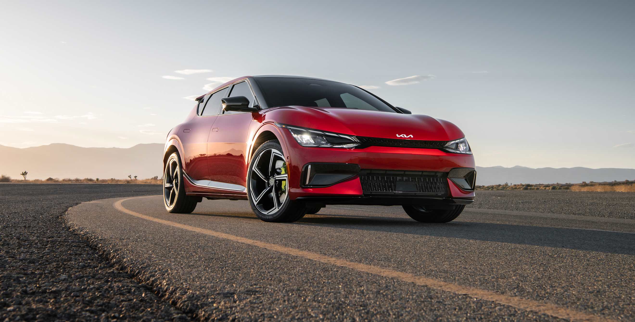 A red 2023 Kia EV6 GT on a closed track.