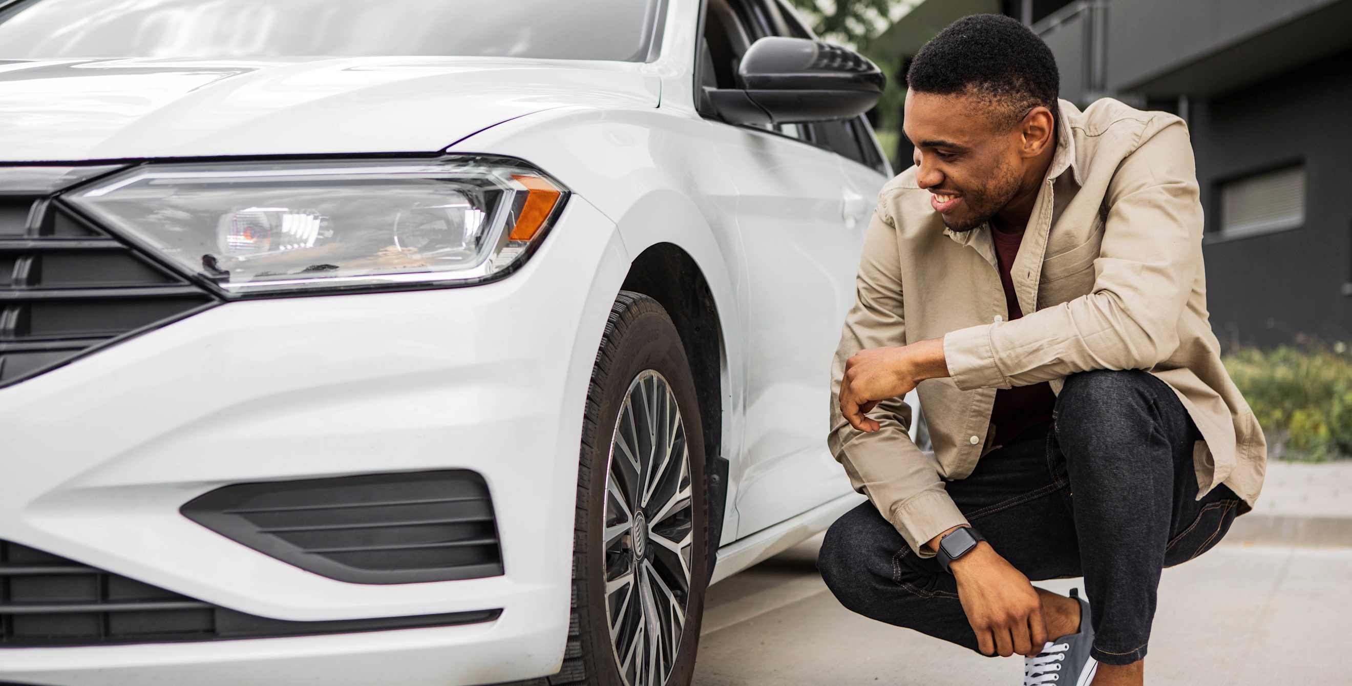 A man admires his new car.