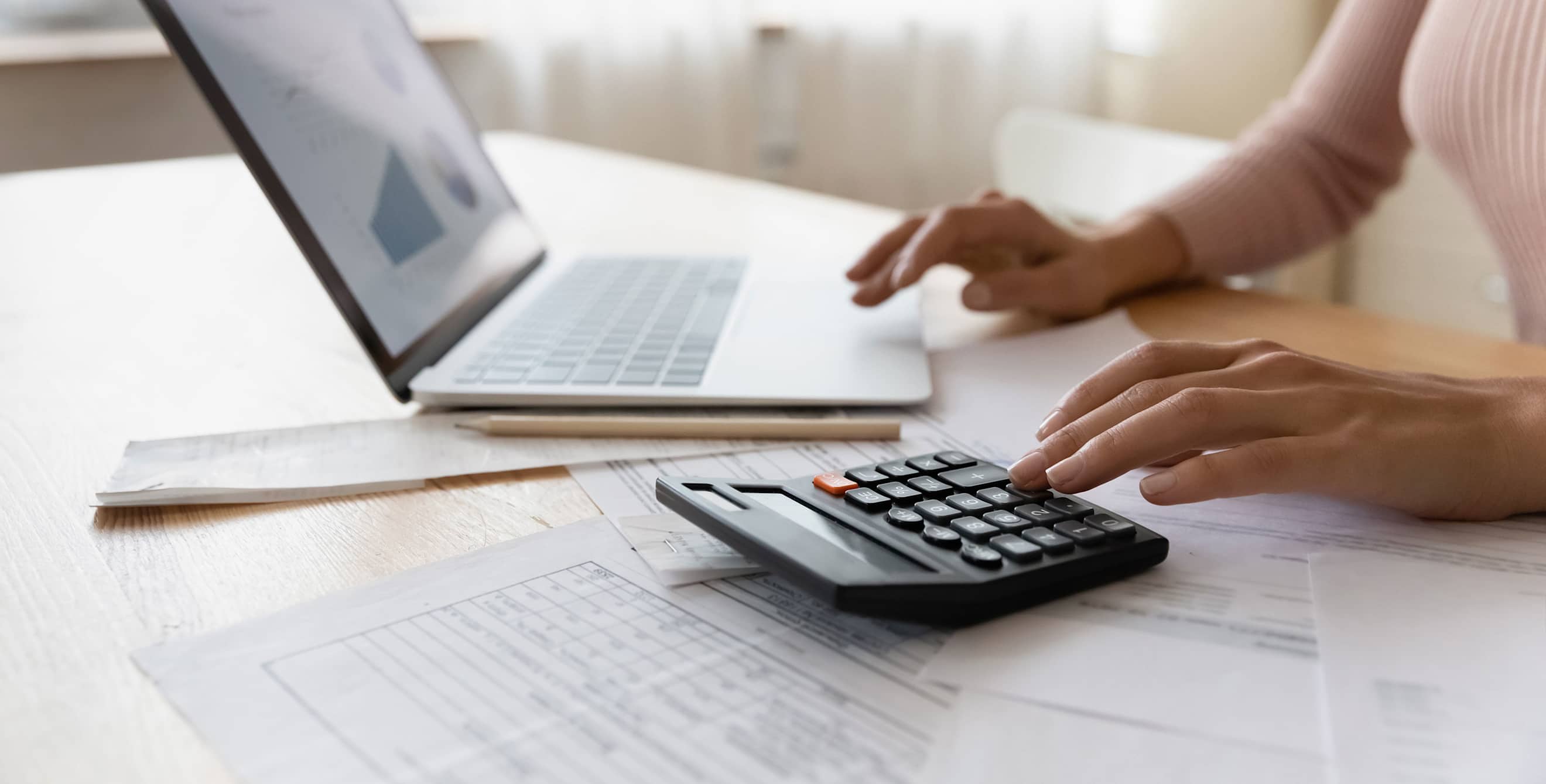 A woman reviews her credit report on her computer.