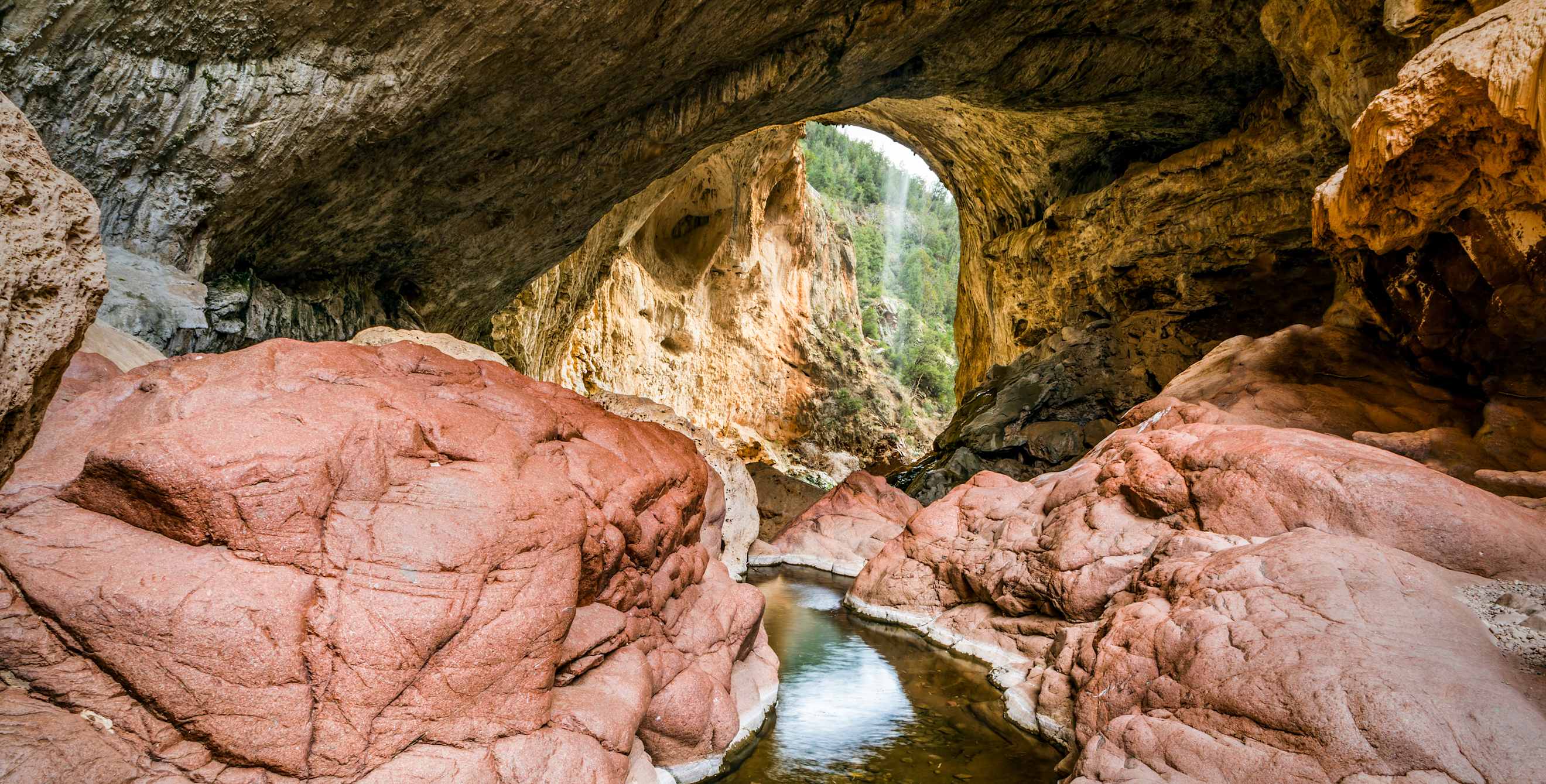 Water under the natural bridge in Tonto Bridge State Park in Arizona
