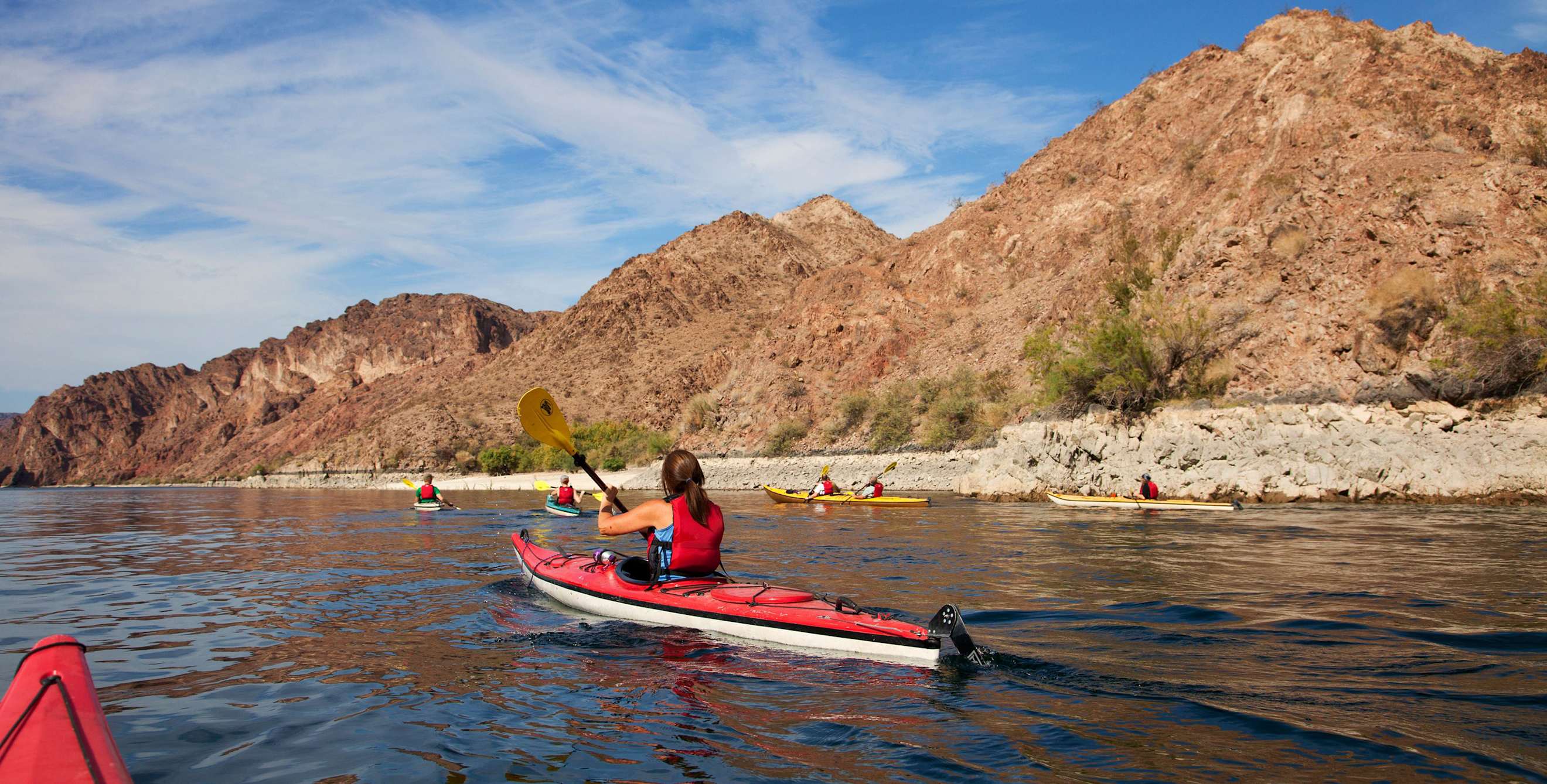 a woman kayaks in Black Canyon in Nevada on the Black Canyon National Water Trail near the Hoover Dam