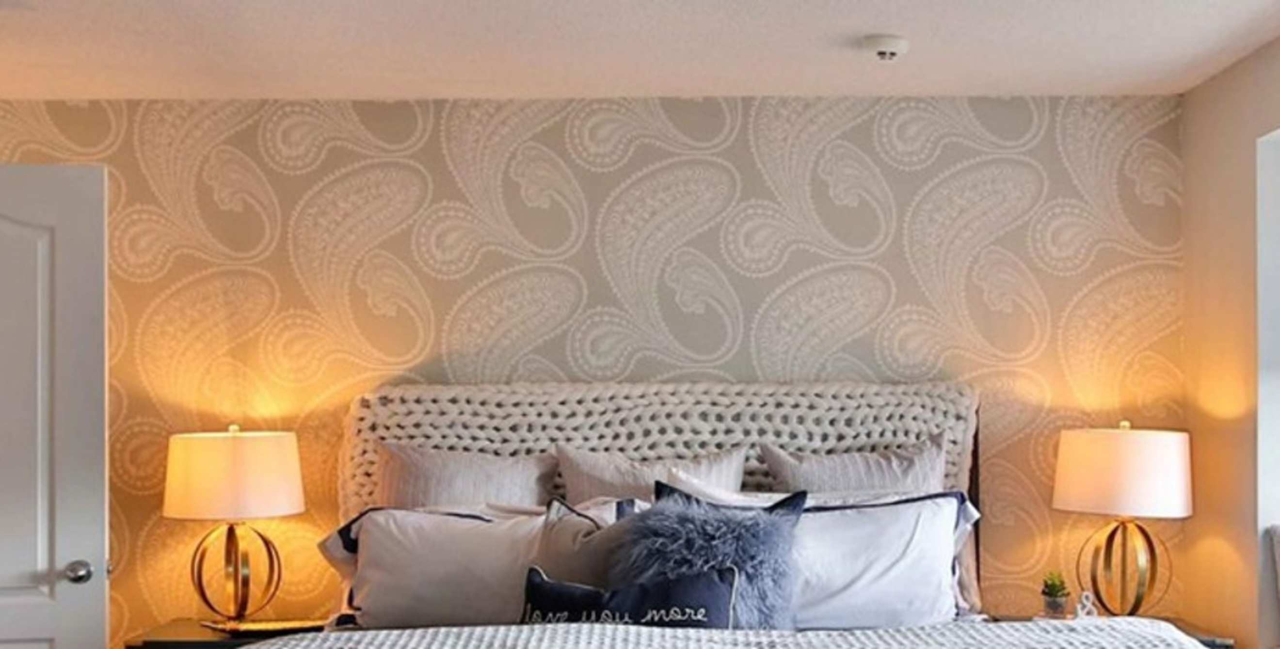 A light bedroom with warm table lights on