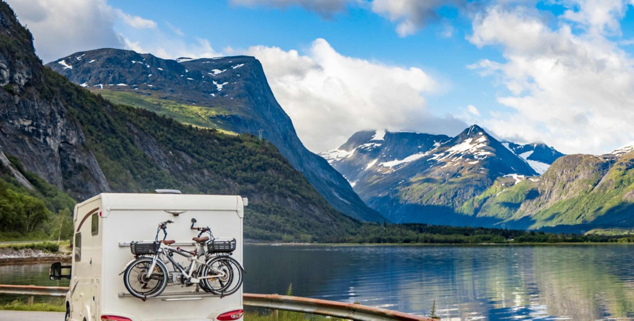 Truck driving next to mountain lake
