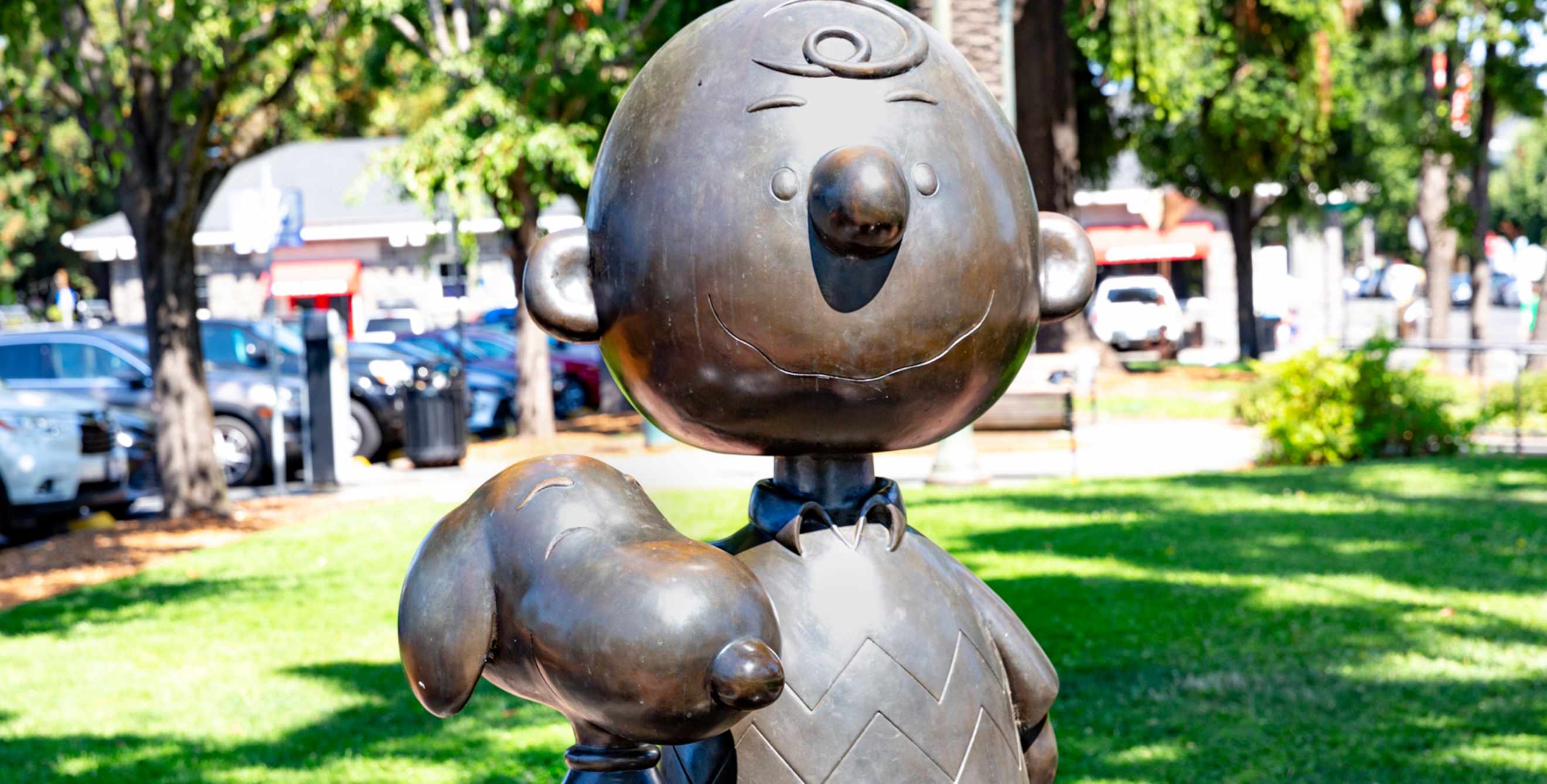 A lifesized bronze statue of Charlie Brown and Snoopy.