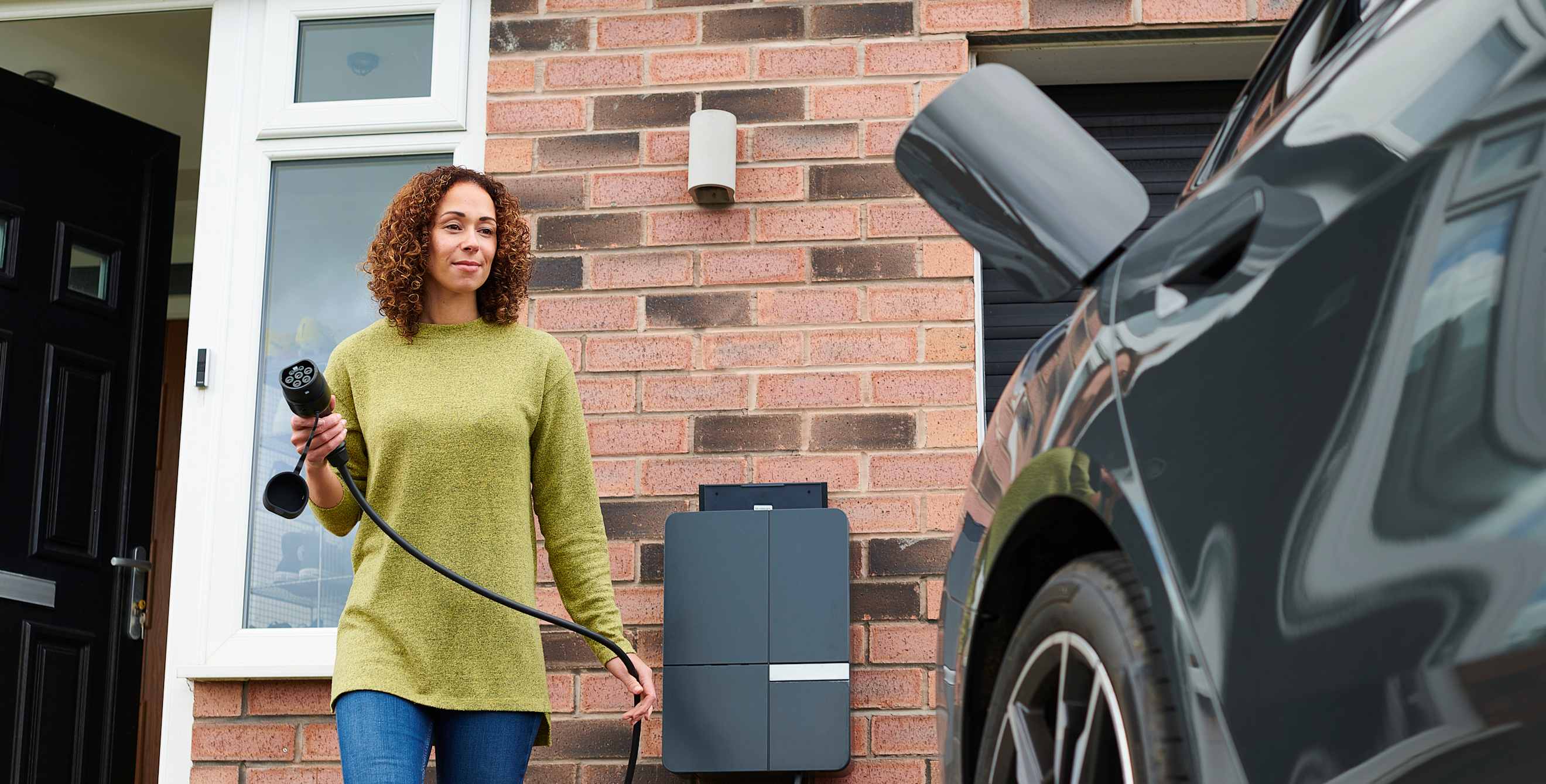 Woman charging her EV