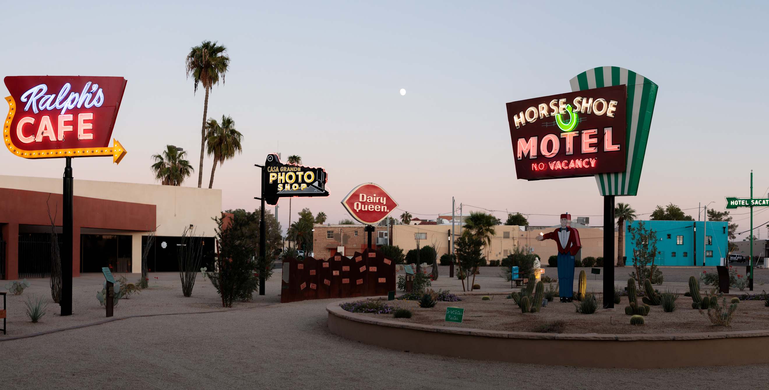 Signs lit up at desk at the Casa Grande Neon Sign Park in Arizona.