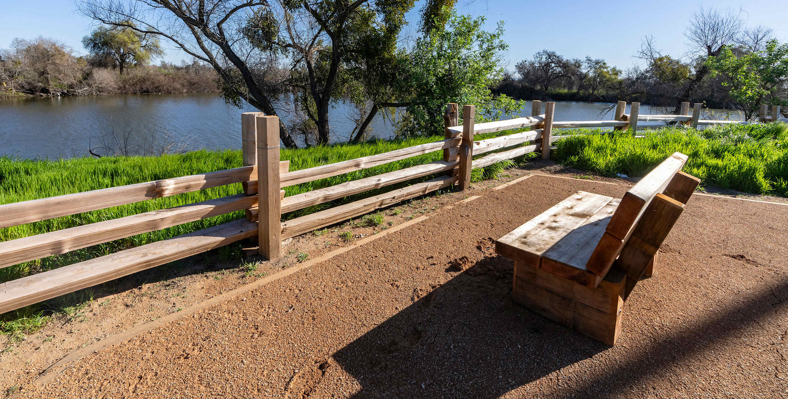 A bench overlooks the pond at Dos Rios State Park in California.