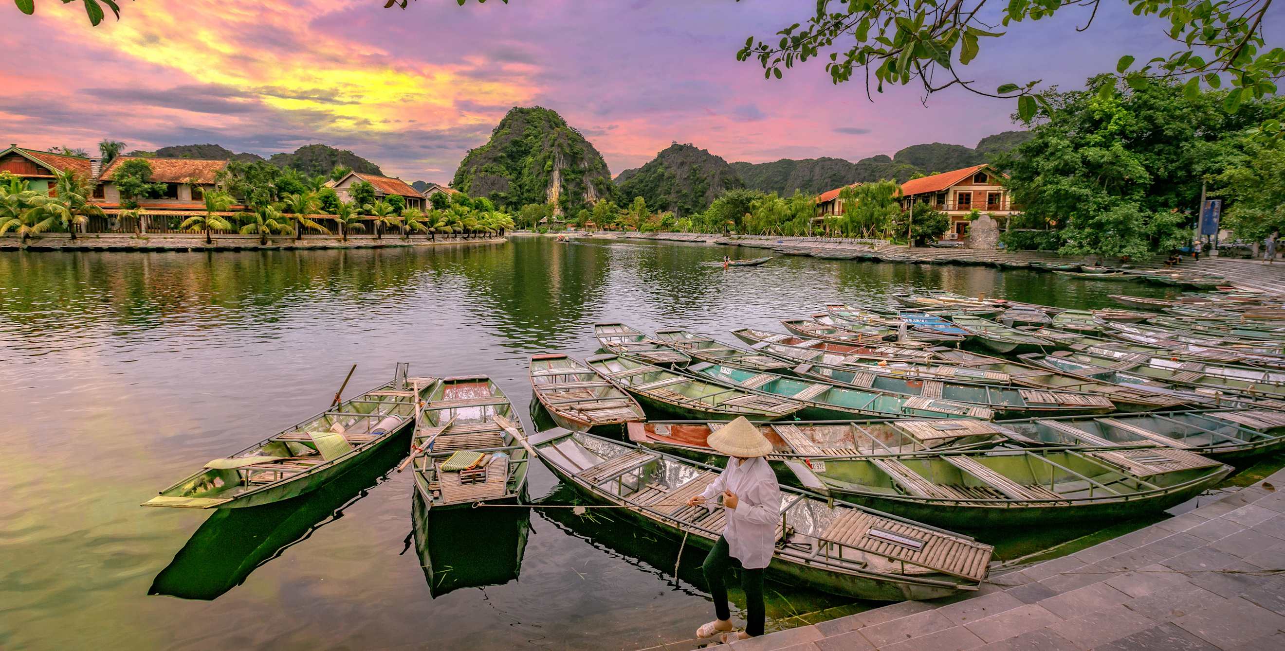 Row boats waiting for passengers at sunrise at Hoa Lu Tam Coc, Hoi An Ancient Town in Vietnam.