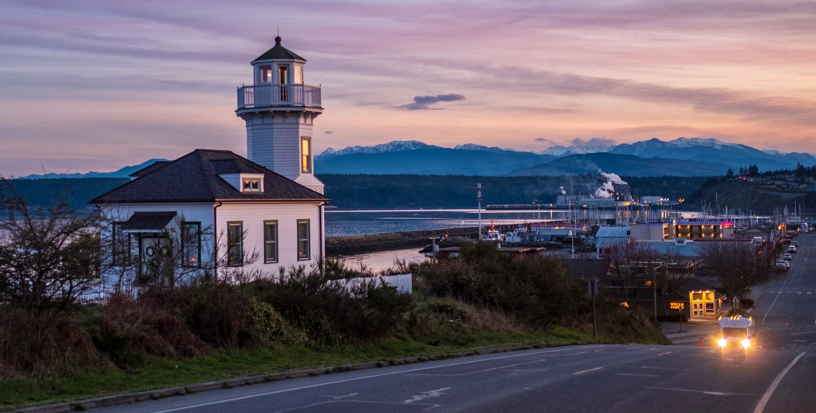 Historic white lighthouse in Port Townsend, Washington at dusk.