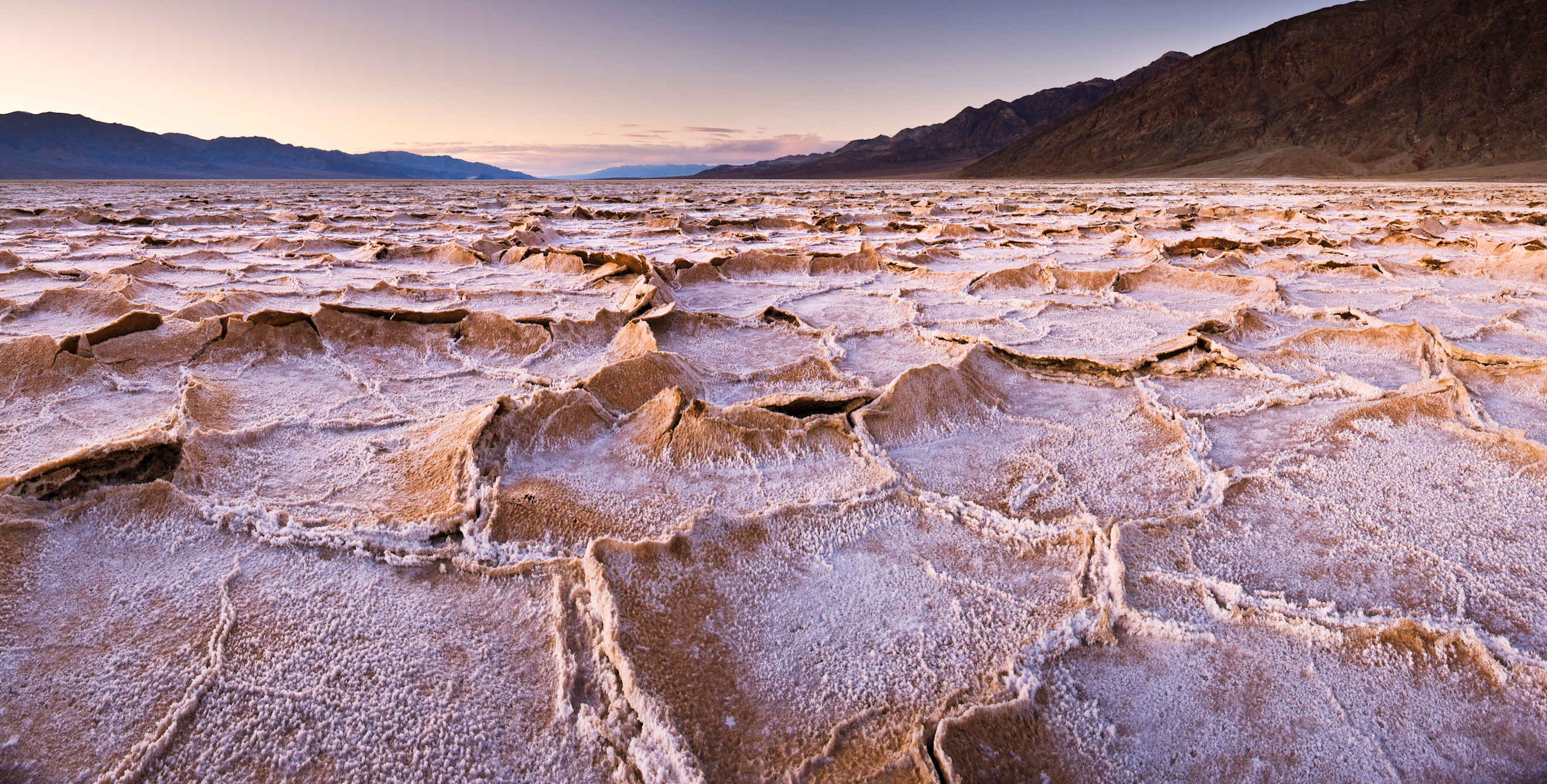 Salt formations in Badwater Basin at dusk in Death Valley National Park, California.