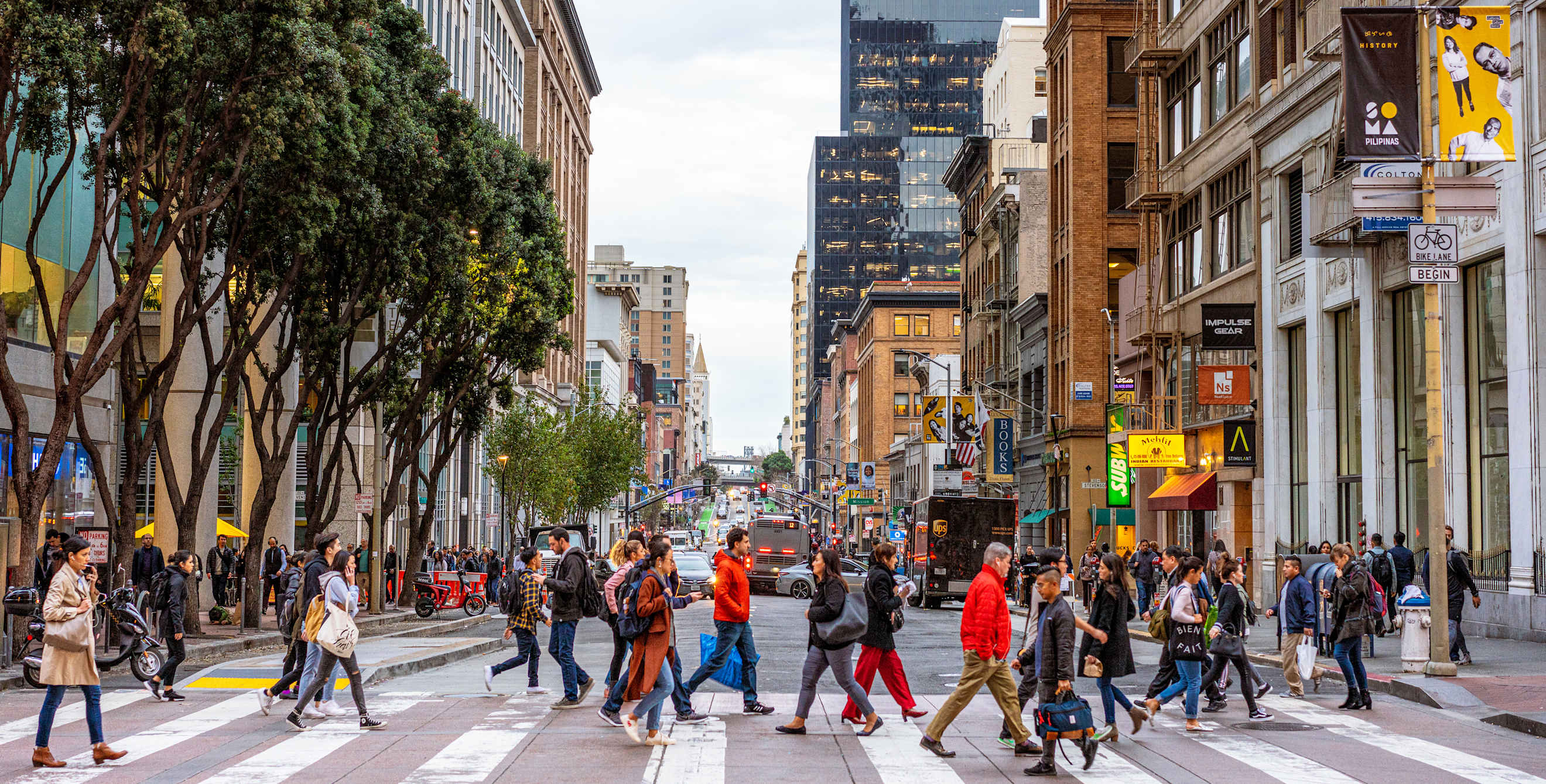 A crowd of pedestrians in a downtown San Francisco crosswalk.