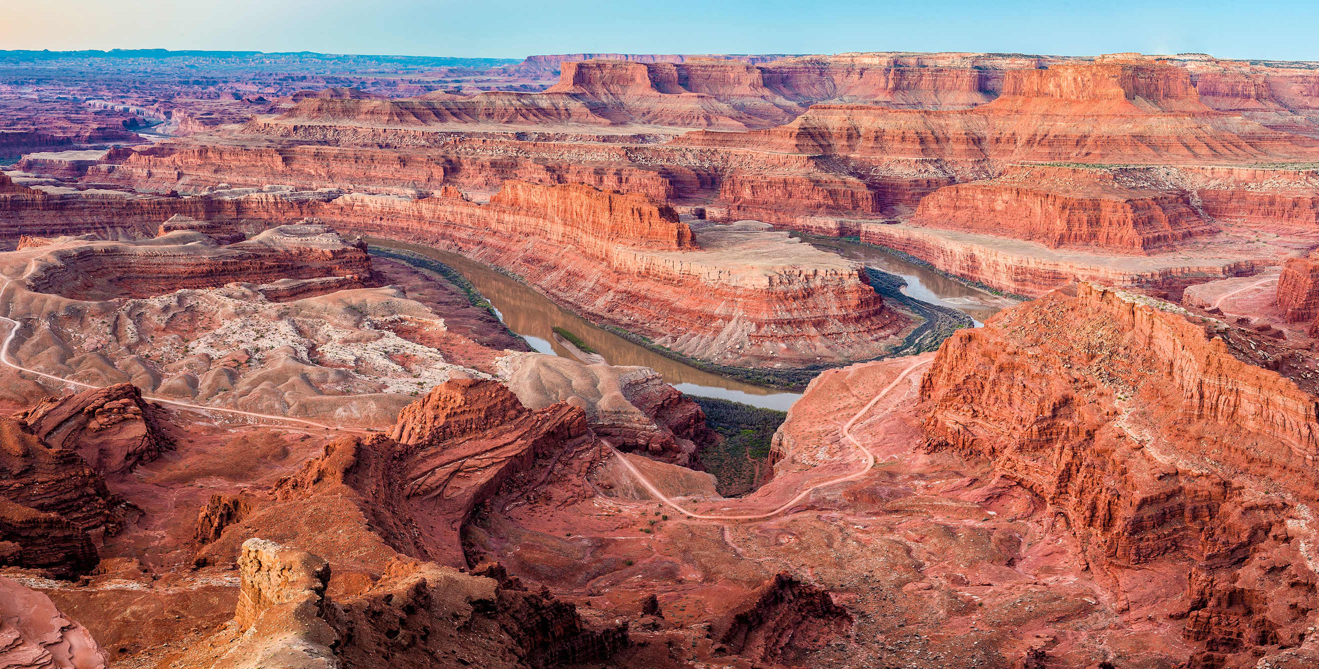 multicolor sandstone cliffs with the Colorado River winding through