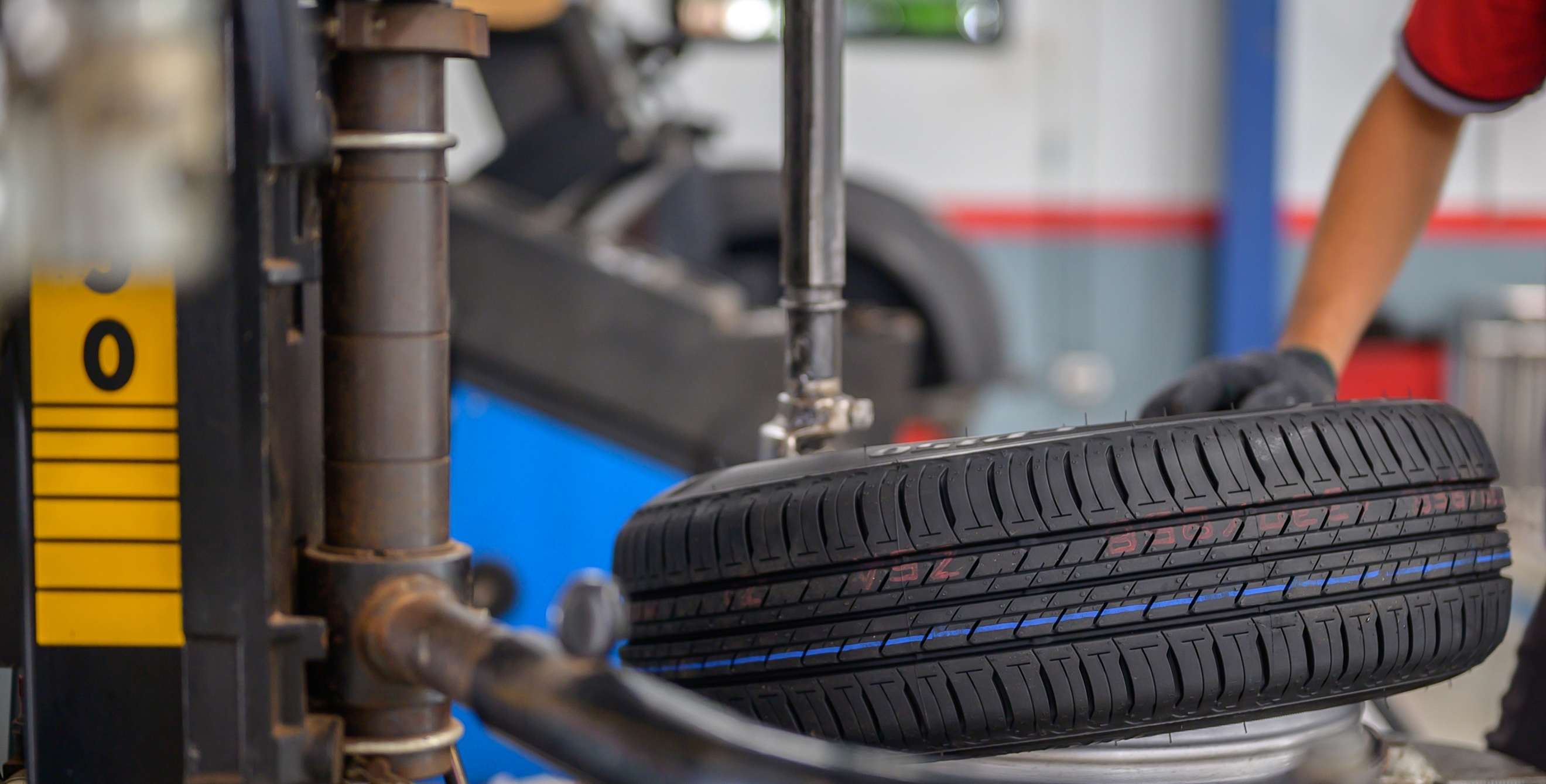 a mechanic places a tire on a machine for rotation