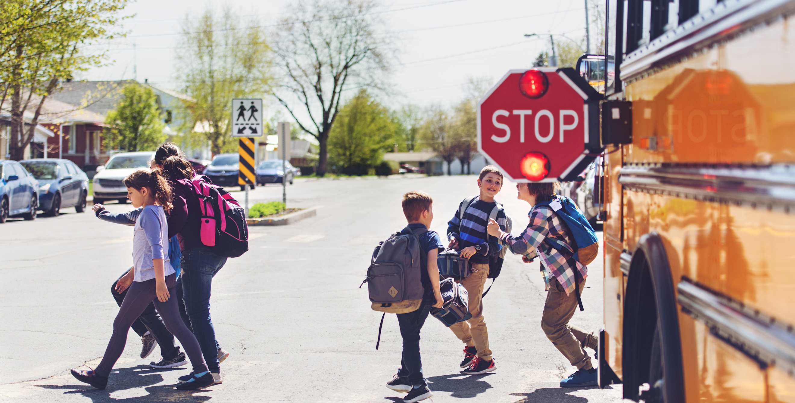kids disembark a school bus