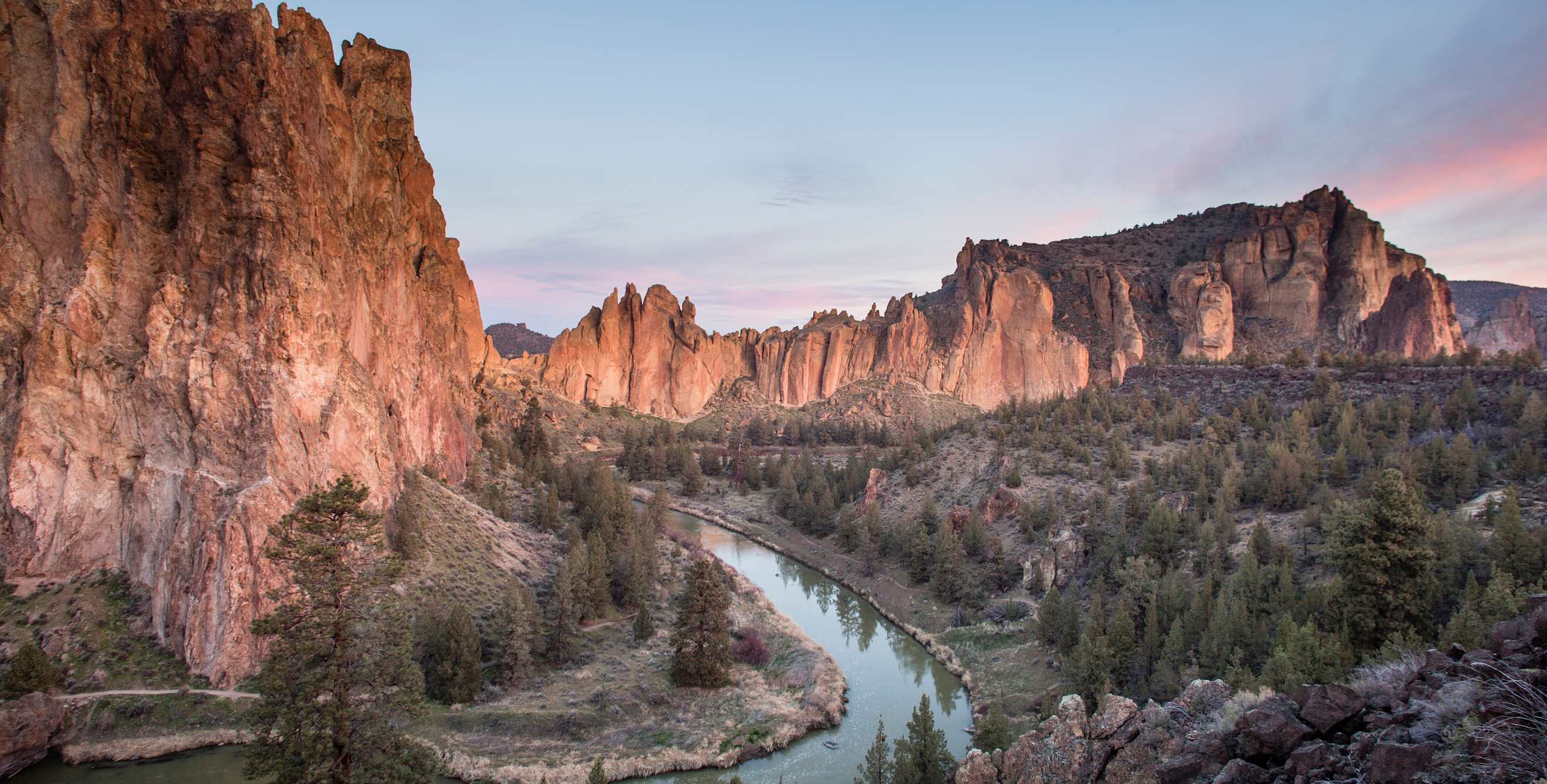 dramatic red rock cliffs with a river below