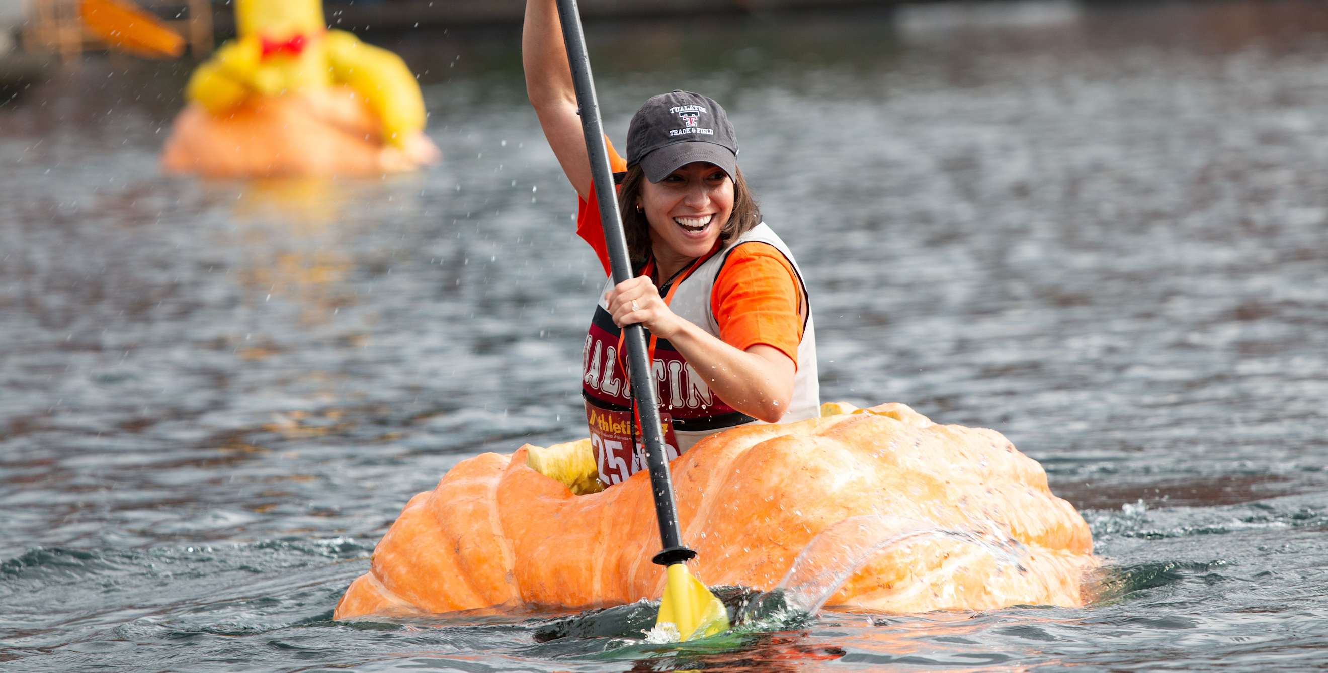 A paddler races to the finish in the West Coast Giant Pumpkin Regatta in Tualatin, Oregon.