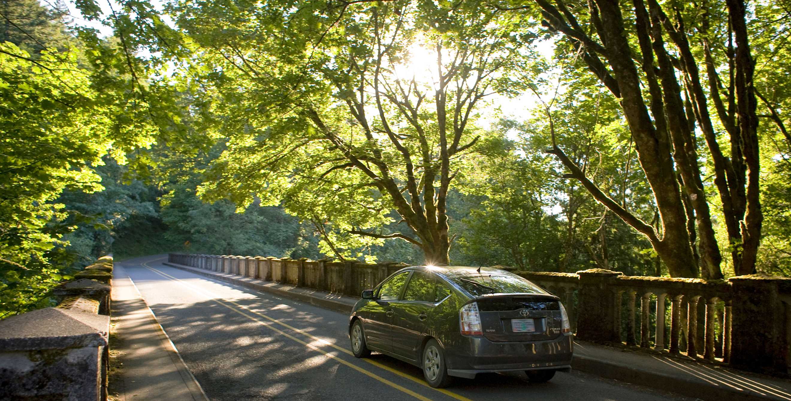 A Toyota Prius hybrid drives on a bridge in Oregon's Columbia River Gorge.