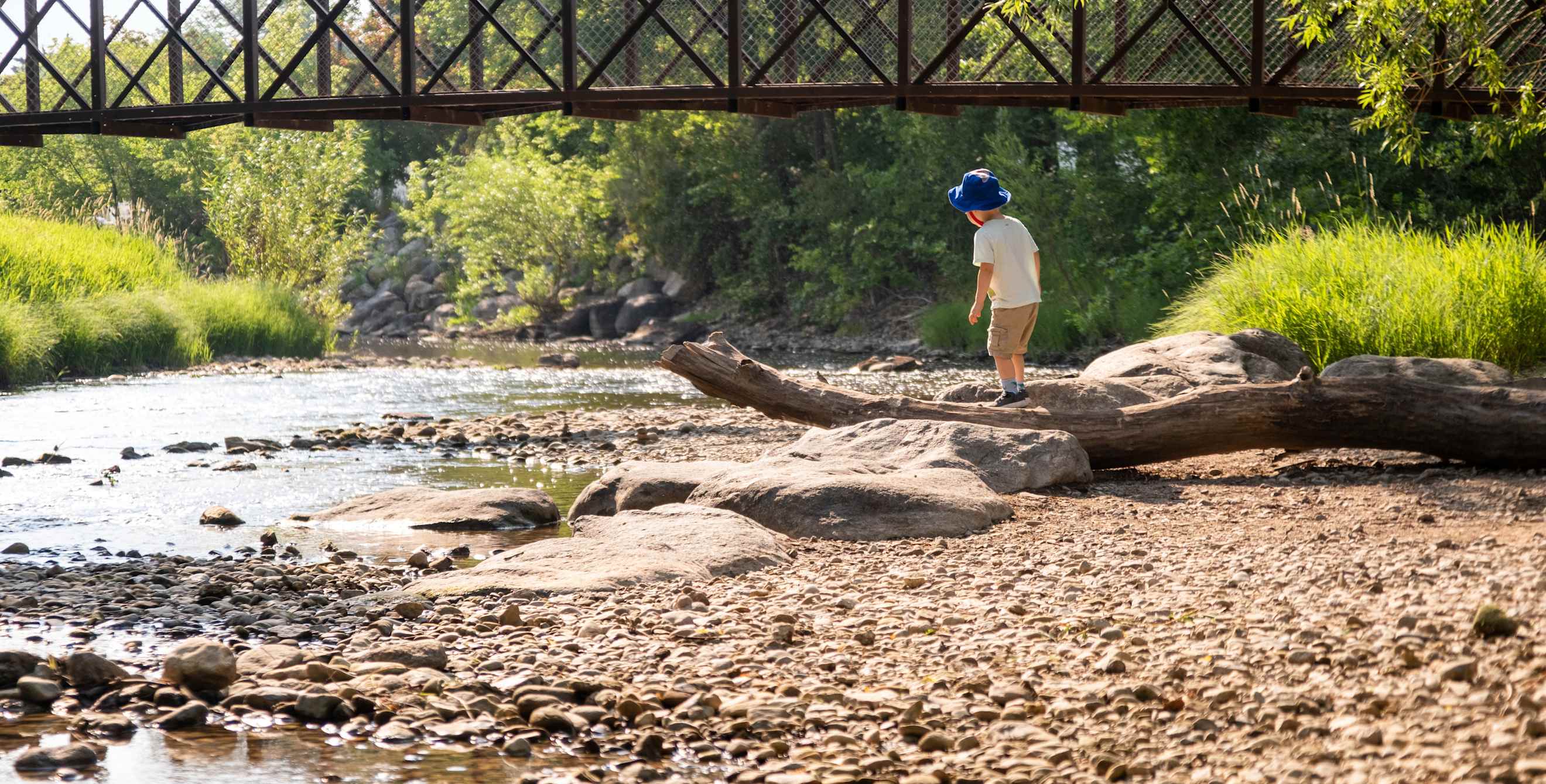 A child plays in Kendrick Park’s cool creek in Sheridan, Wyoming.