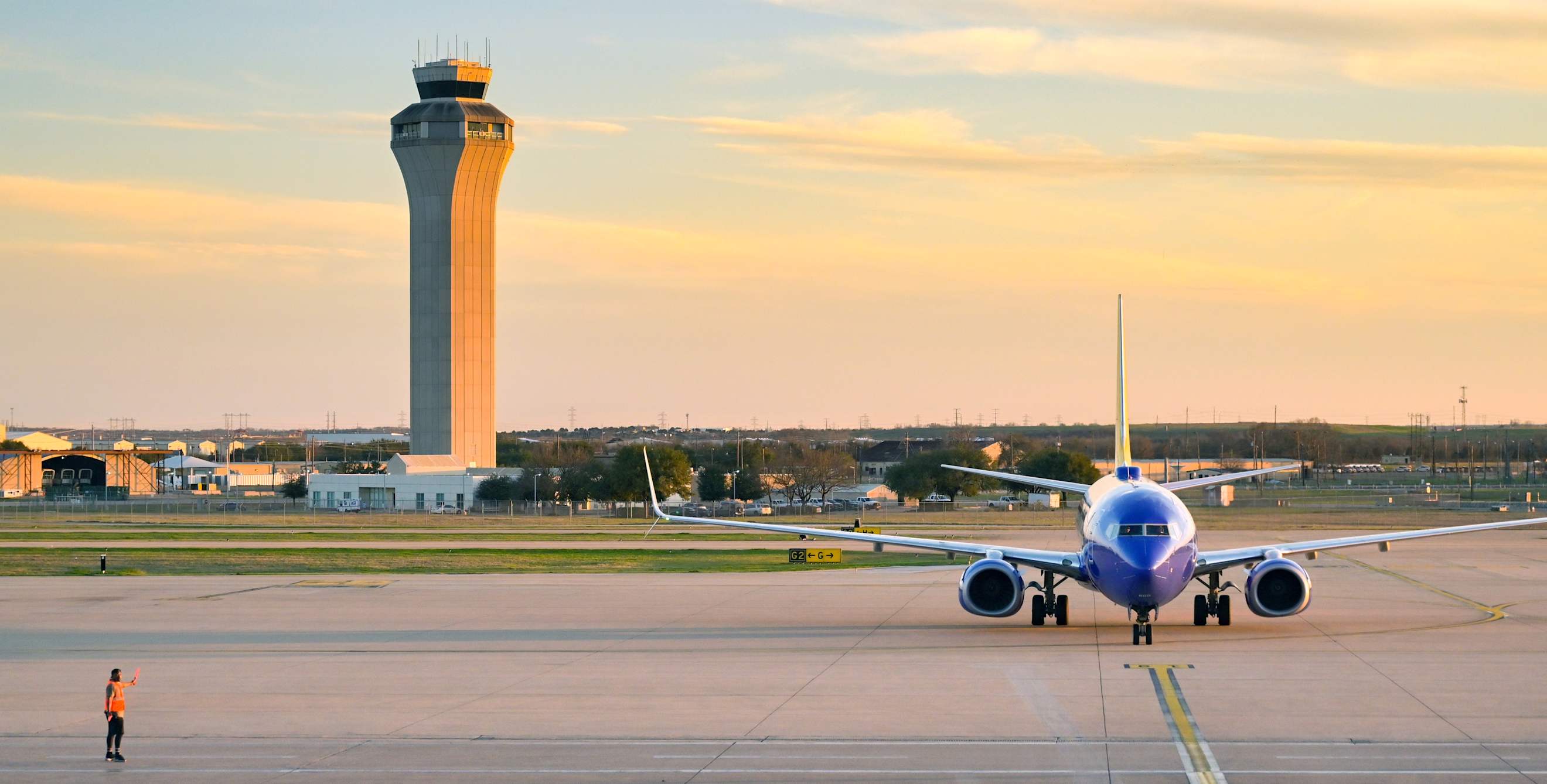 Boeing 737 passenger jet arriving at the airport terminal at Austin-Bergstrom International Airport.