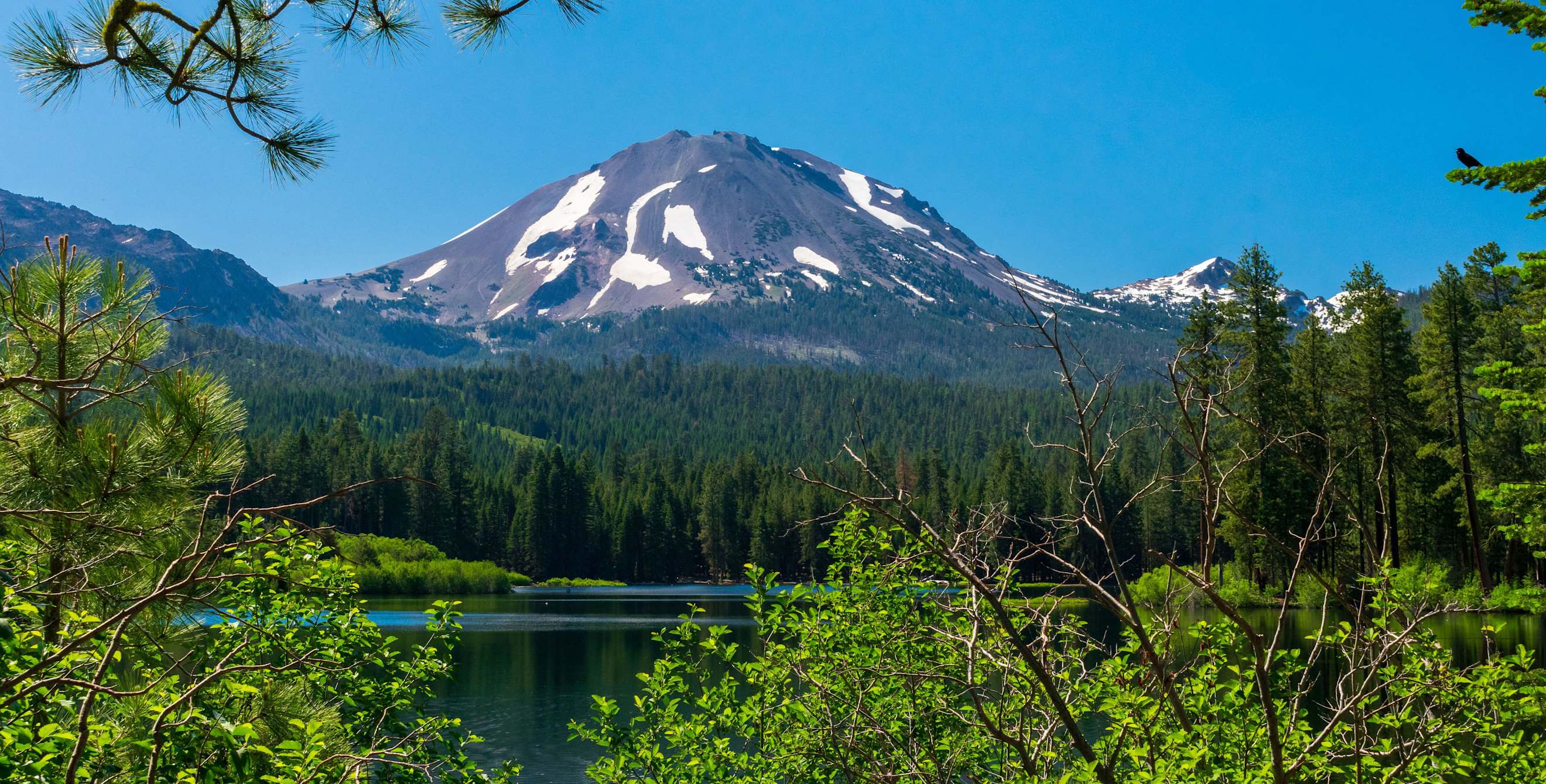 Lassen Peak reflects in Manzanita Lake in Lassen Volcanic National Park, California.