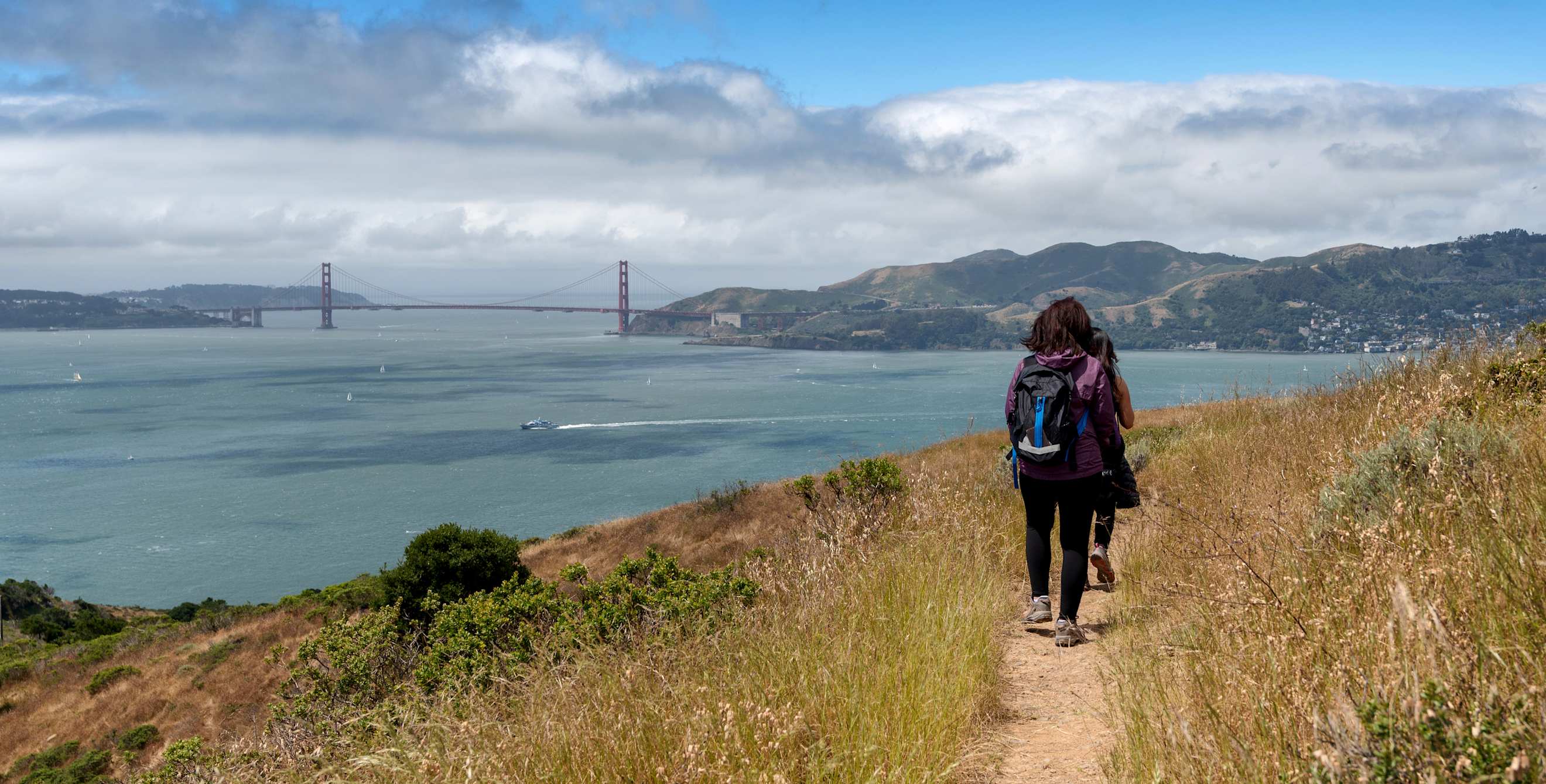 Two hikers on the trail to Mt. Livermore on Angel Island in the San Francisco Bay.