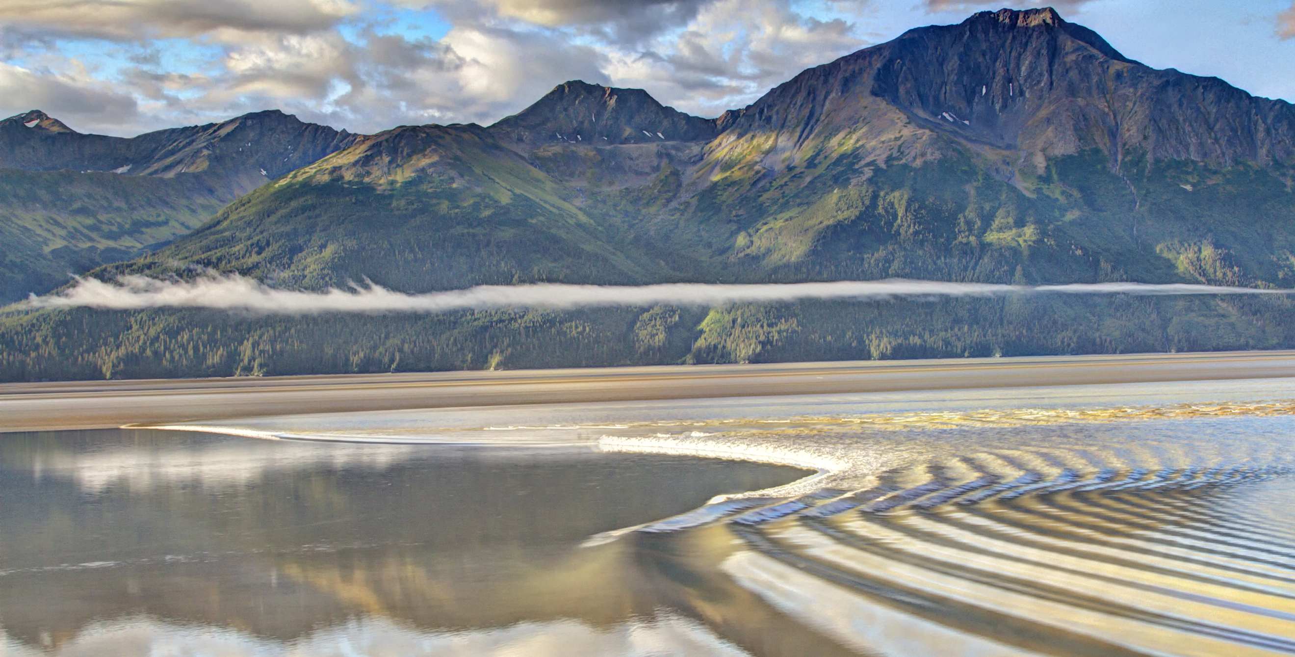The bore tide washes into Turnagain Arm in Alaska.