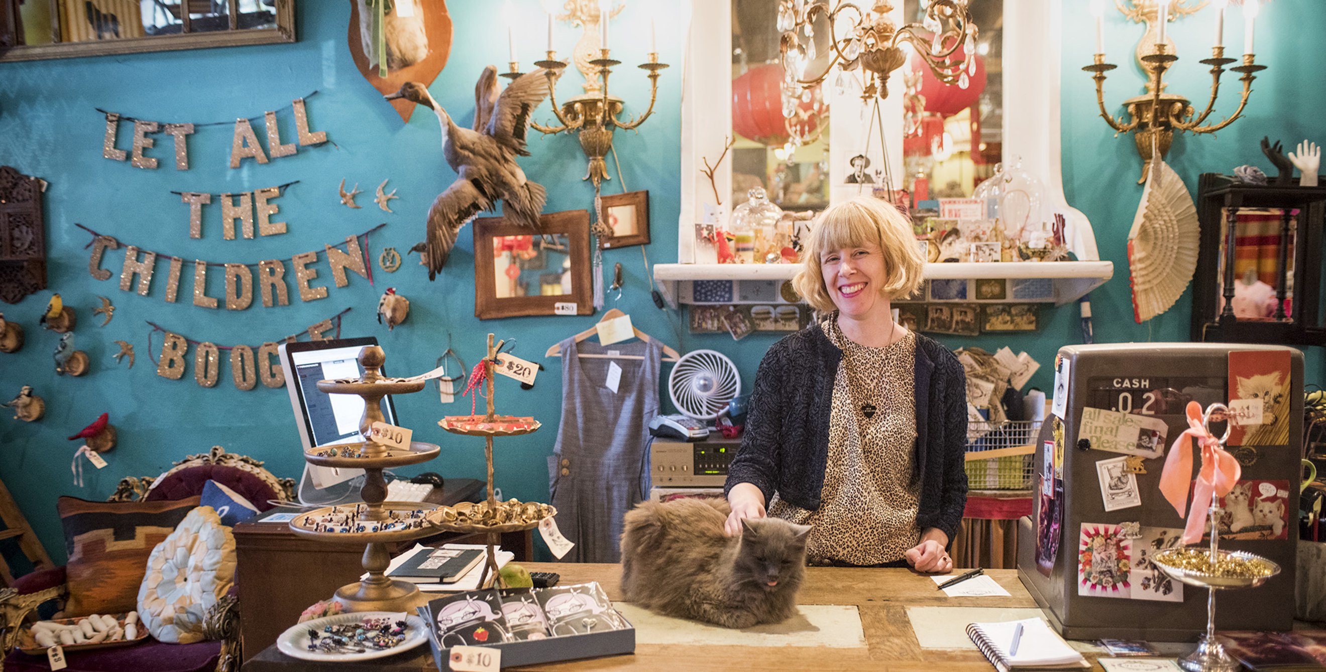 a clerk pets the store cat at curiosity-filled Flutter